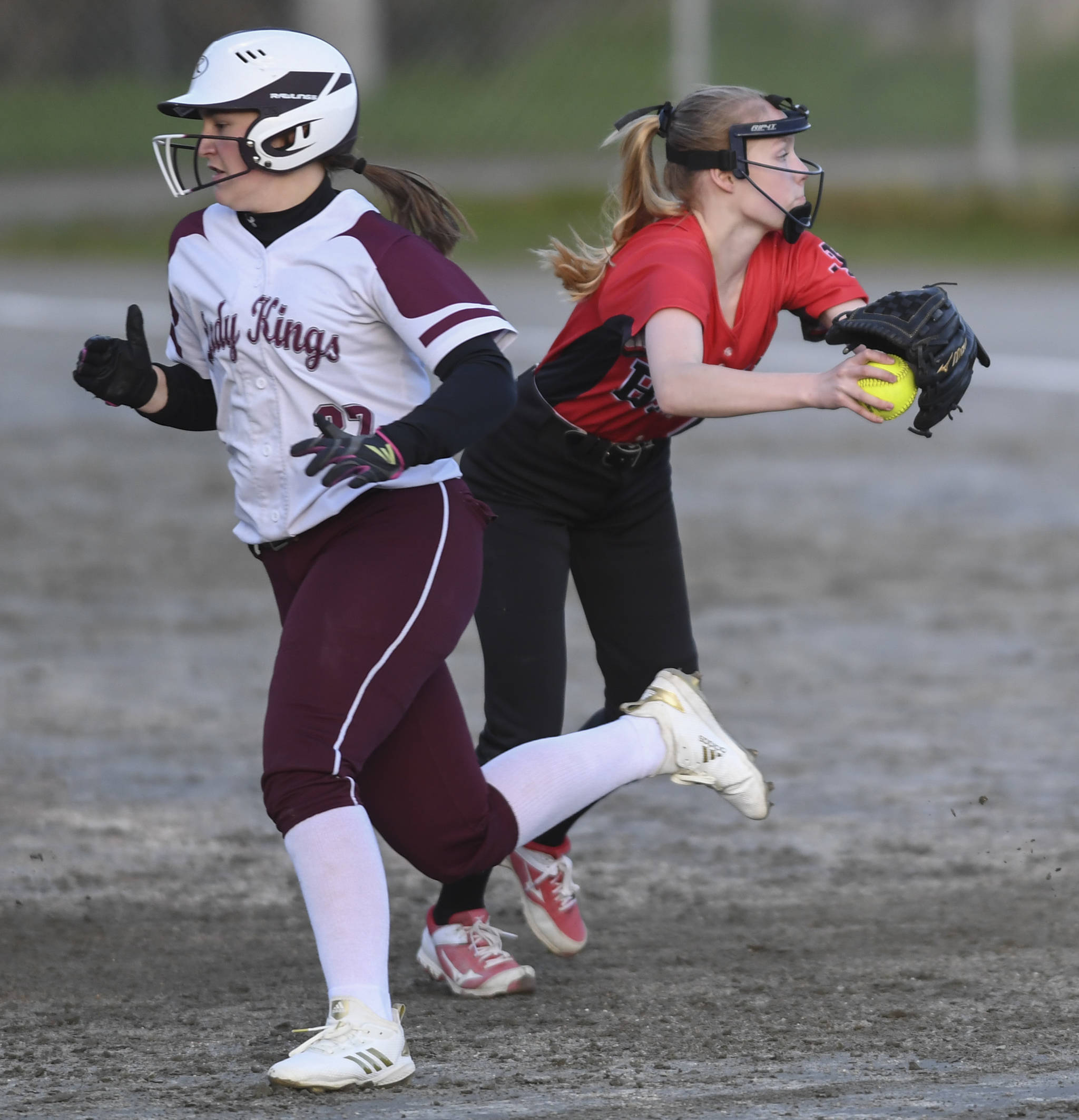 Ketchikan’s Dyllan Borer gets by Juneau-Douglas’ Margot Oliver in the four inning at Melvin Park on Thursday, May 9, 2019. Ketchikan won 13-0. (Michael Penn | Juneau Empire)