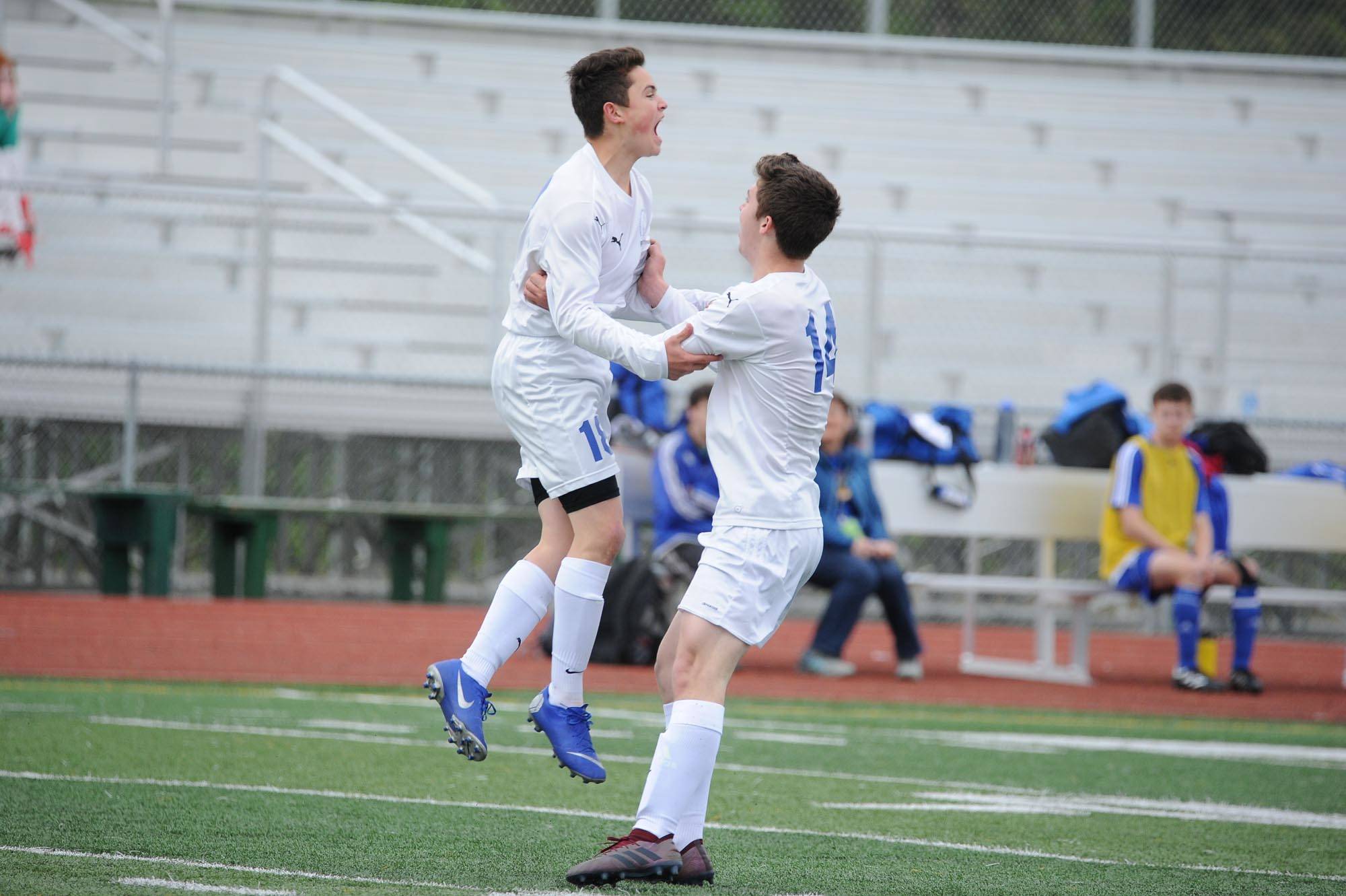 Thunder Mountain’s Matthew Hartsock and Jacob Babcock celebrate one of Hartsock’s first-half goals during their ASAA/First National Bank Alaska soccer state championship match with Monroe Catholic Thursday evening at Service High School in Anchorage. (Michael Dinneen | For the Juneau Empire)