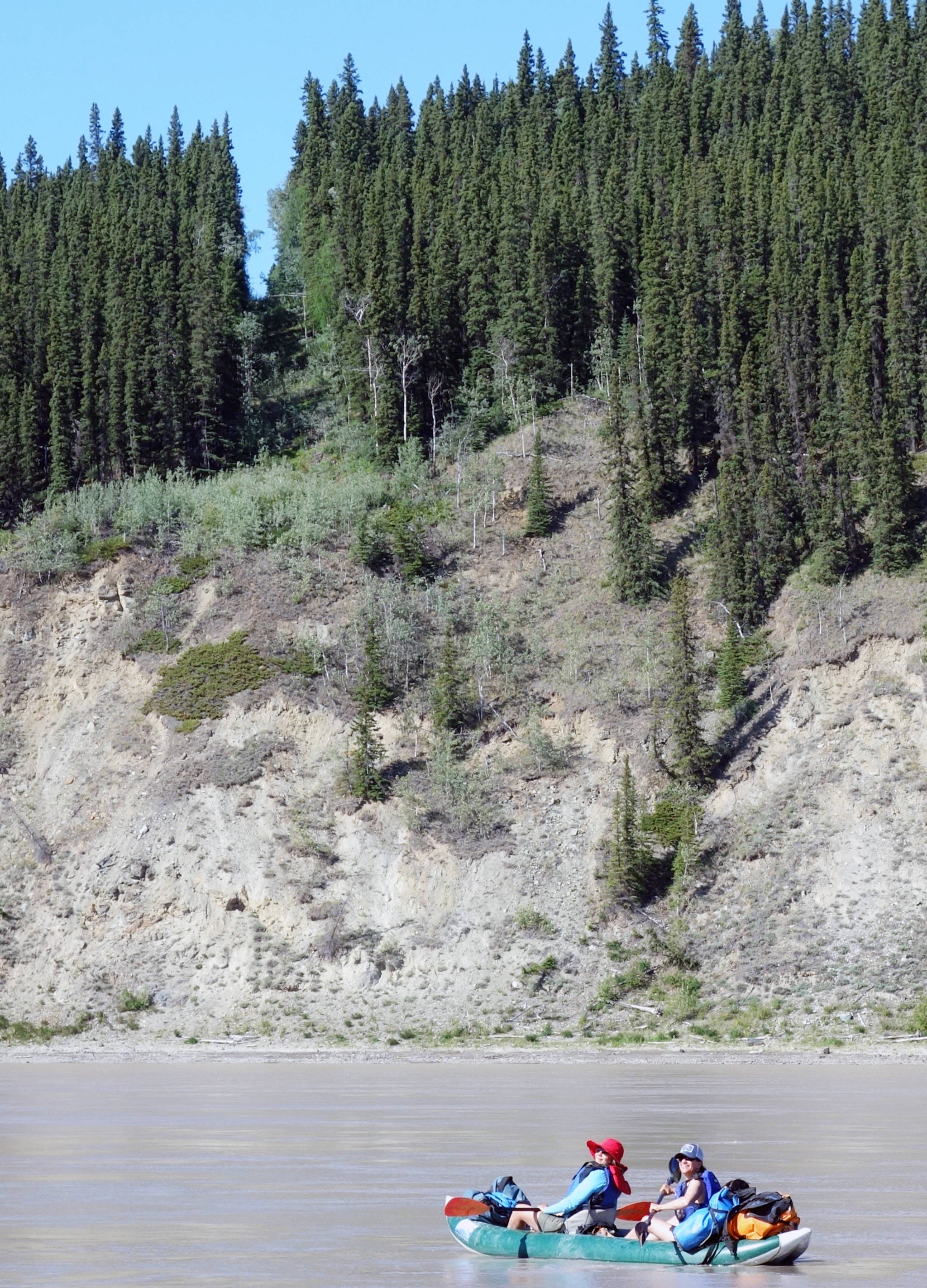 Two boaters on the Yukon River cross from the Yukon into Alaska on July 5. The border is marked by a 20-foot clearing and a metal obelisk. (Courtesy Photo | Ned Rozell)