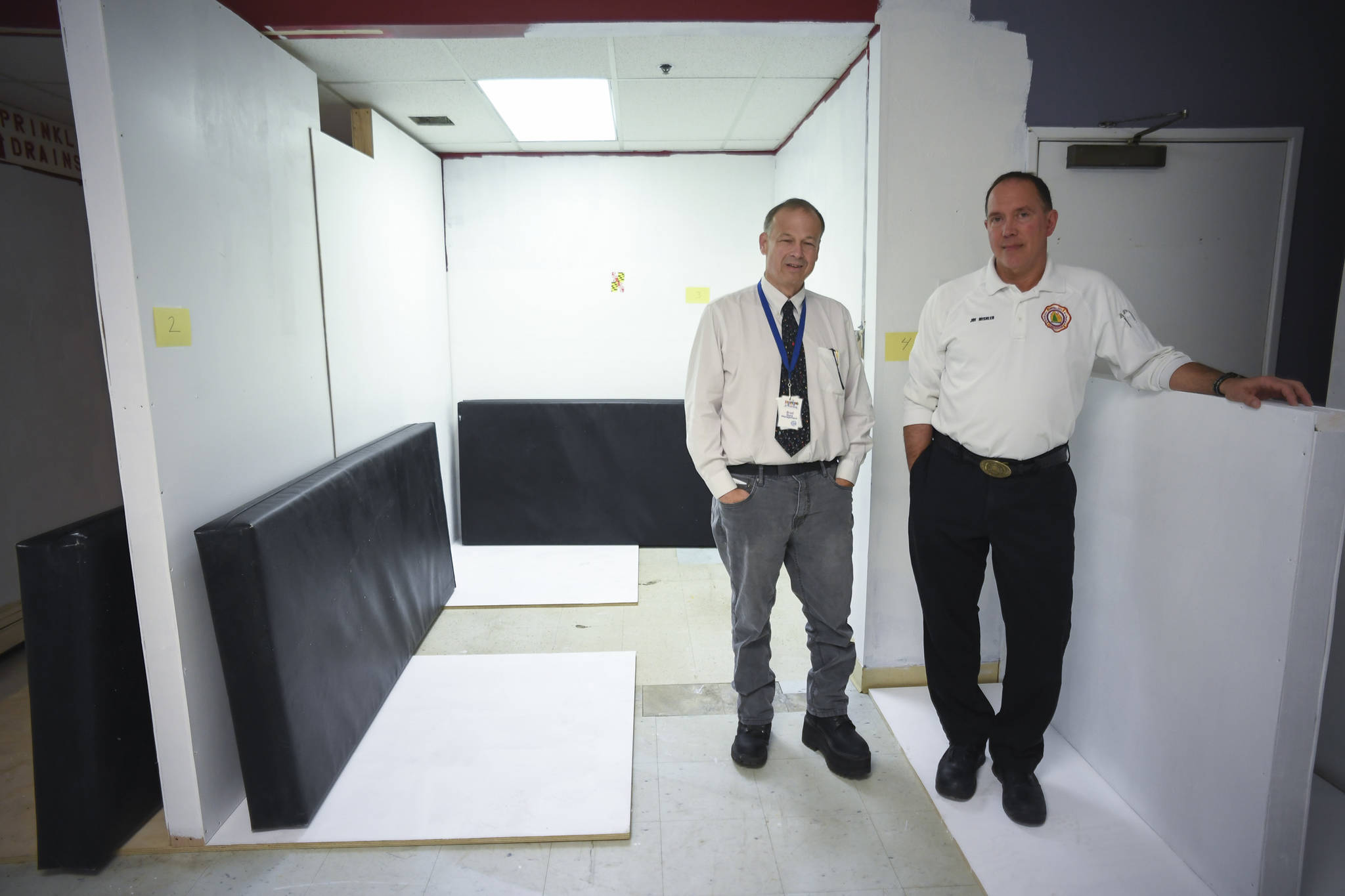 Bradley Perkins, General Manager of St. Vincent de Paul Society Juneau, left, and Joe Mishler, the Emergency Medical Services Training Officer for Capital City Fire/Rescue, stand in a temporary space created as a sleep off center at the Dan Austin Transitional Support Service Center at St. Vincent de Paul on Friday, July 19, 2019. (Michael Penn | Juneau Empire)