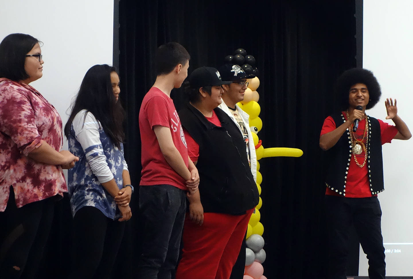 Members of Ix̱six̱án, Ax̱ Ḵwáan Jaylynn Martin, Jordan Bennett, Keegan Kanan, Arturo Rodriguez and Colin Rose watch Arias Hoyle explain the meaning behind the song and music video “Spirit” Saturday, Aug. 3, 2019. (Ben Hohenstatt | Capital City Weekly)