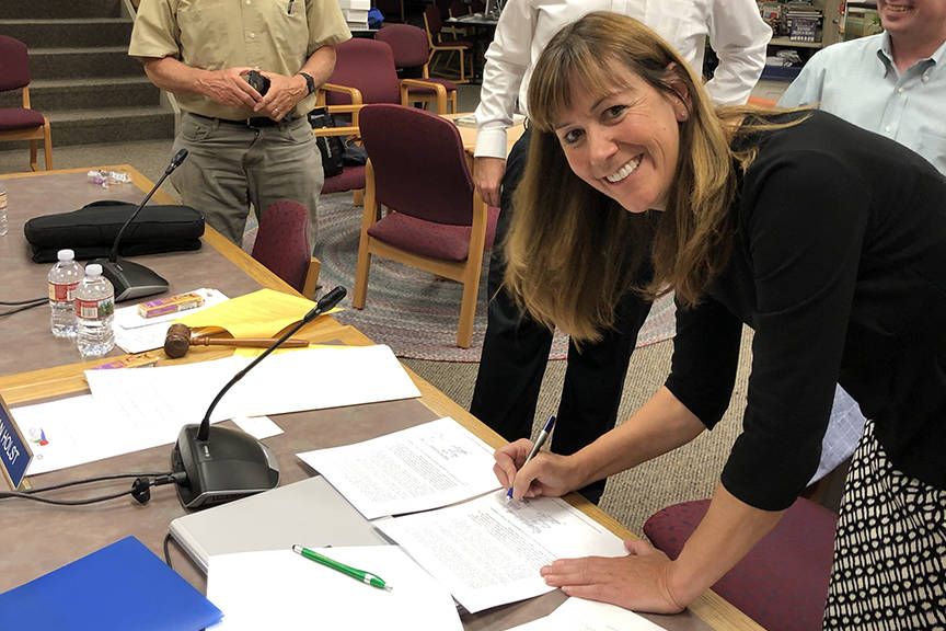 Juneau School District Superintendent Bridget Weiss signs her new contract following the Board of Education meeting at Juneau-Douglas High School: Yadaa.at Kalé on Tuesday, Sept. 10, 2019. (Photo courtesy of Kristin Bartlett)