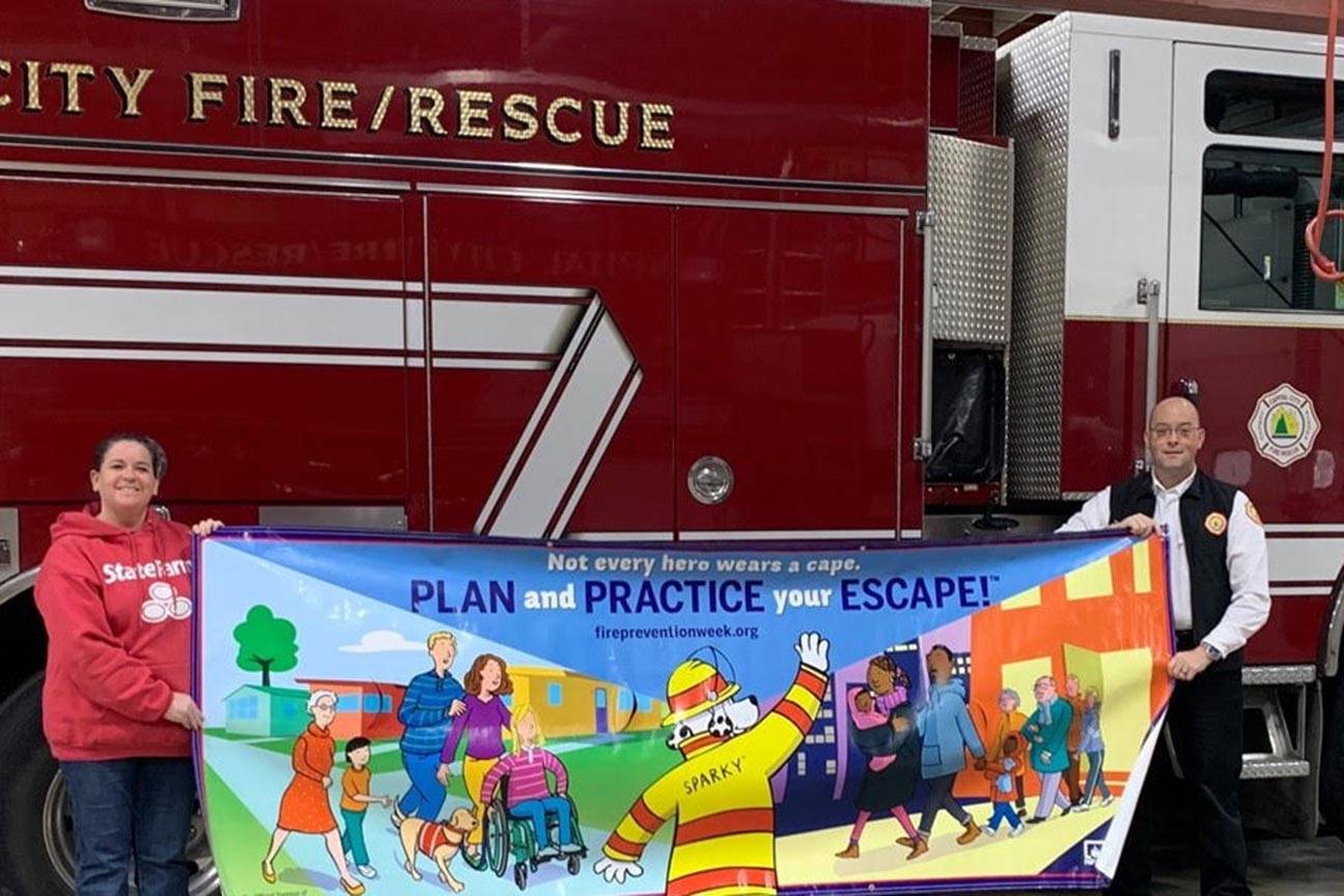 State Farm insurance agent Robin Lonas and Capital City Fire/Rescue fire marshall Dan Jager pose for a photo during Fire Prevention Week, Oct. 9, 2019. (Courtesy Photo)