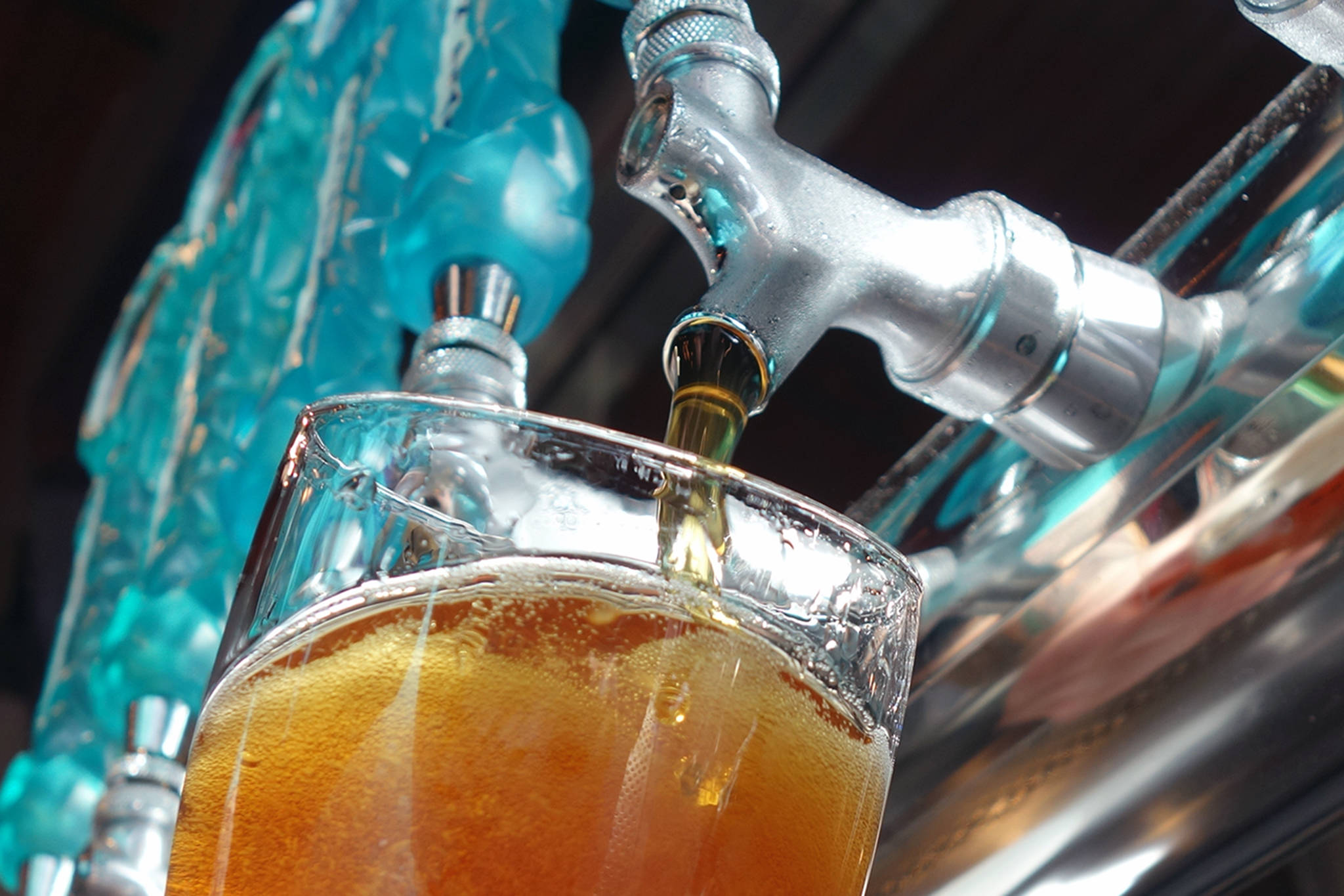 Zac Watt, beertender for Forbidden Peak Brewery, pours a beer during the grand opening for the Auke Bay business, Saturday, Oct. 12,2019. (Ben Hohenstatt | Juneau Empire)