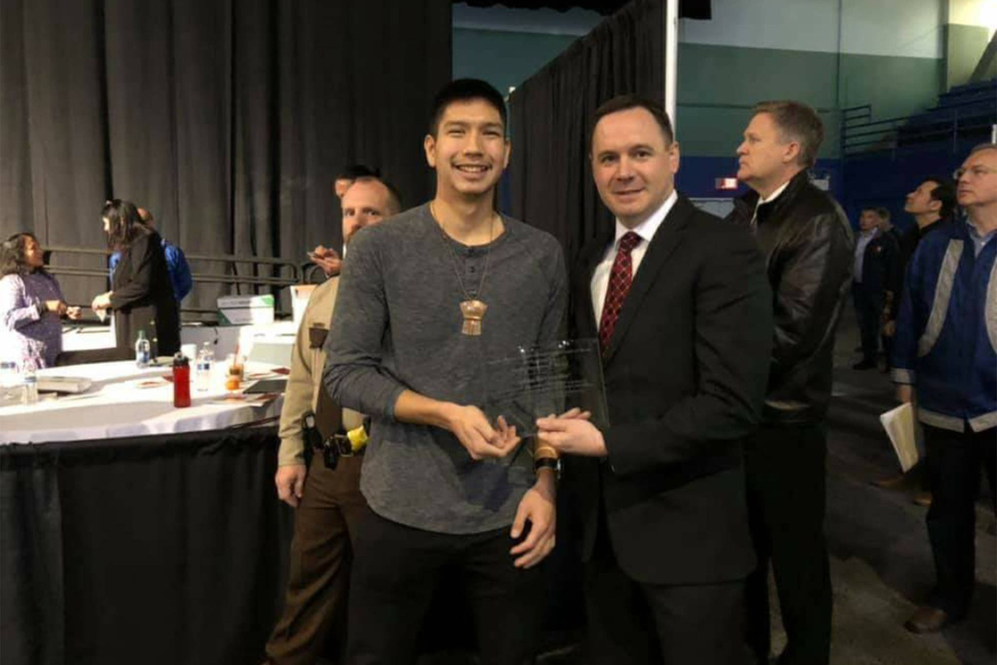 Kake High School graduate Simon Friday, left, and Juneau-Douglas High School: Yadaat.at Kale boys basketball coach Robert Casperson show off the Shirley Demientieff Award at the Alaska Federation of Natives annual convention in Fairbanks on Thursday, Oct. 17, 2019. (Couresy Photo | Simon Friday)