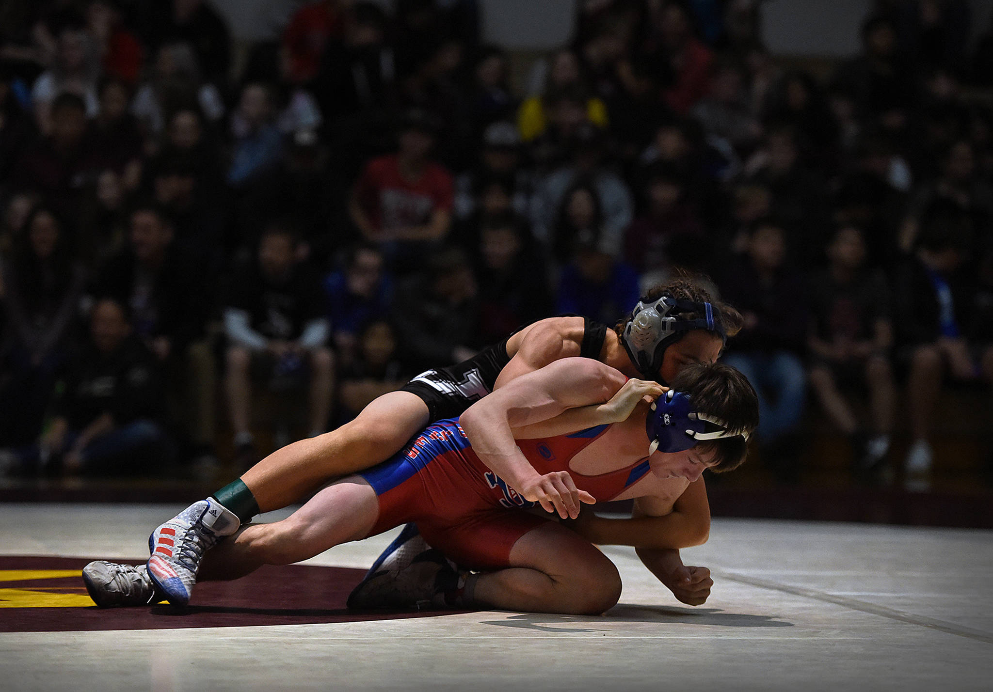 Thunder Mountain High School’s Kadin Messmer works for top position against Sitka High School’s Colton Ewers in the 112-pound finals of the Bill Weiss Invitational at Ketchikan High School on Saturday, Nov. 2, 2019. (Dustin Safranek | Ketchikan Daily News)