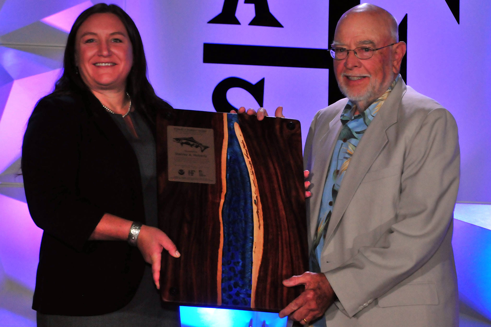 American Fisheries Society President Jesse Trushenski presents Stan Moberly the first Stanley A. Moberly Award for Outstanding Contributions in Fish Habitat Conservation. (Courtesy Photo | American Fisheries Society)