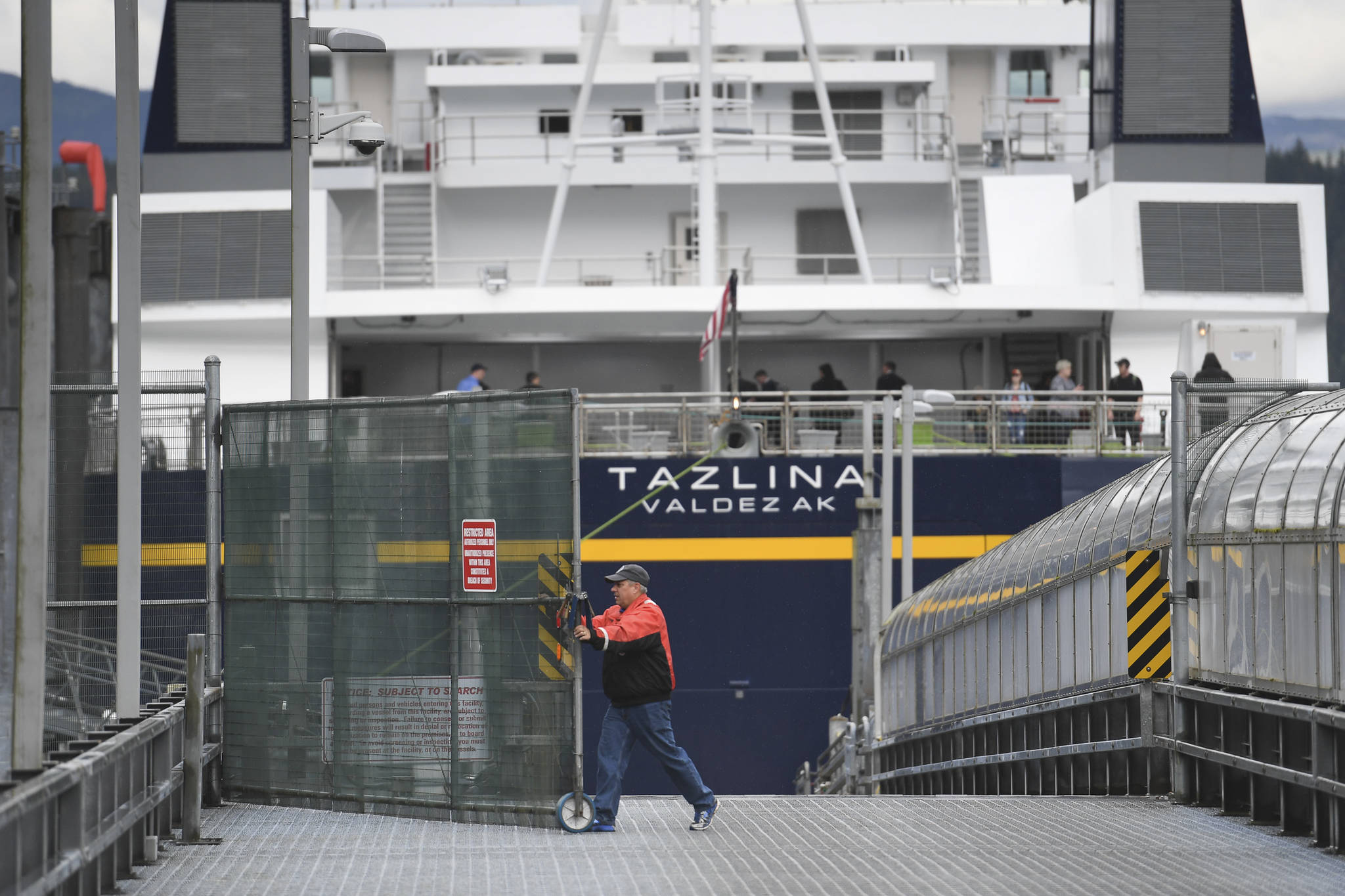 In this file photo, the Alaska Marine Highway System employee opens the vehicle gate after the Tazlina arrives at the Auke Bay Terminal on Wednesday, July 24, 2019. (Michael Penn | Juneau Empire File)