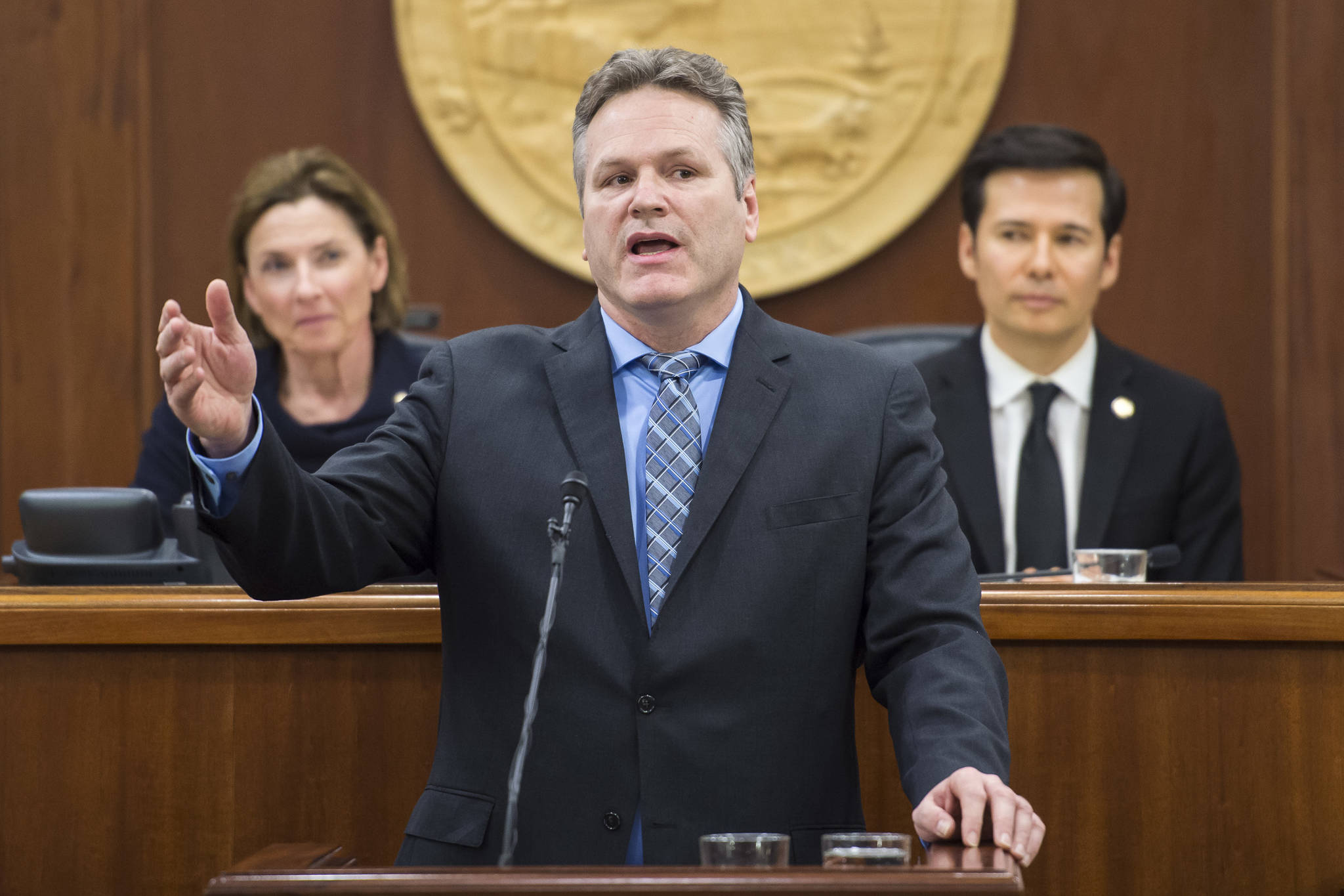 Gov. Mike Dunleavy give his State of the State speech to a Joint Session of the Alaska Legislature as Senate President Cathy Giessel, R-Anchorage, left, and House Speaker Pro Tempore Rep. Neal Foster, D-Nome, listen at the Capitol on Tuesday, Jan. 22, 2019. (Michael Penn | Juneau Empire File)