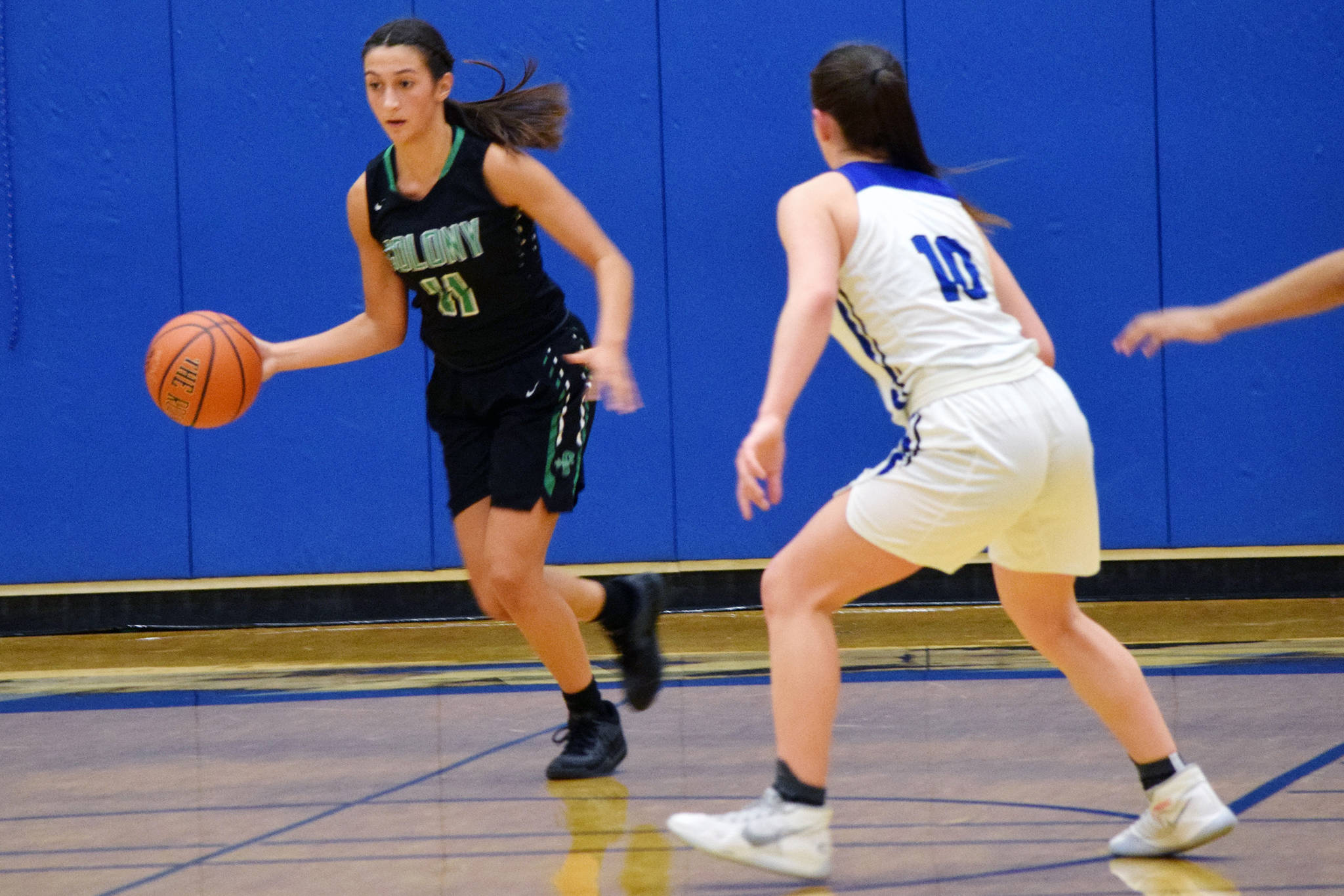 Colony High School’s Madison Dunlop dribbles up the court while Thunder Mountain’s Riley Traxler defends in the closing moments of the Knights’ 53-40 win over the Falcons at TMHS on Saturday, Jan. 5, 2020. (Nolin Ainsworth | Juneau Empire)