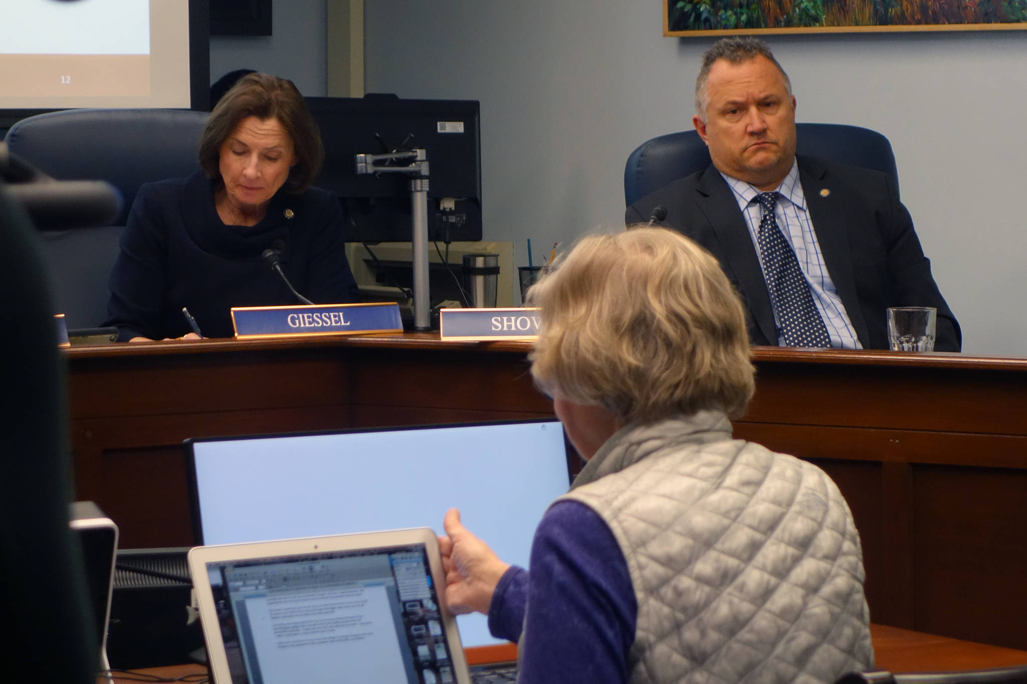 Sen. Cathy Giessel, R-Anchorage, and Sen. Mike Shower, R-Wasilla, listen Margie Beedle give testimony Monday. (Ben Hohenstatt | Juneau Empire)