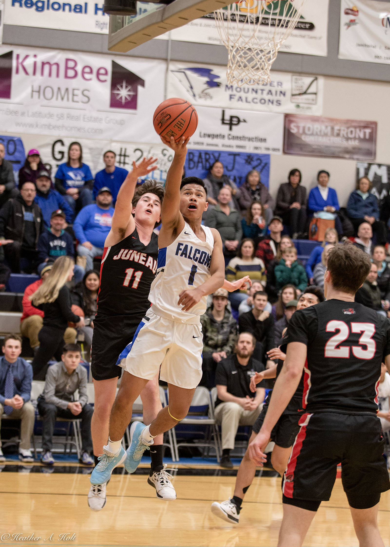 Brady Carandang drives to the hoop Saturday during a game against Juneau-Douglas High School: Yadaa.at Kalé. (Courtesy Photo | Heather Holt)