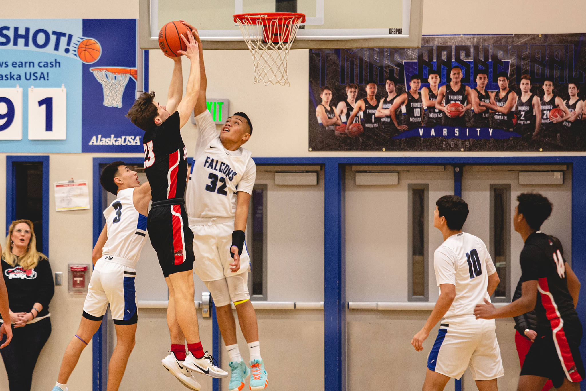 Thunder Mountain High School’s Meki Toutaiolepo contests a shot by Juneau-Douglas High School: Yadaa.at Kalé’s Cooper Kriegmont. (Courtesy Photo | Heather Holt)