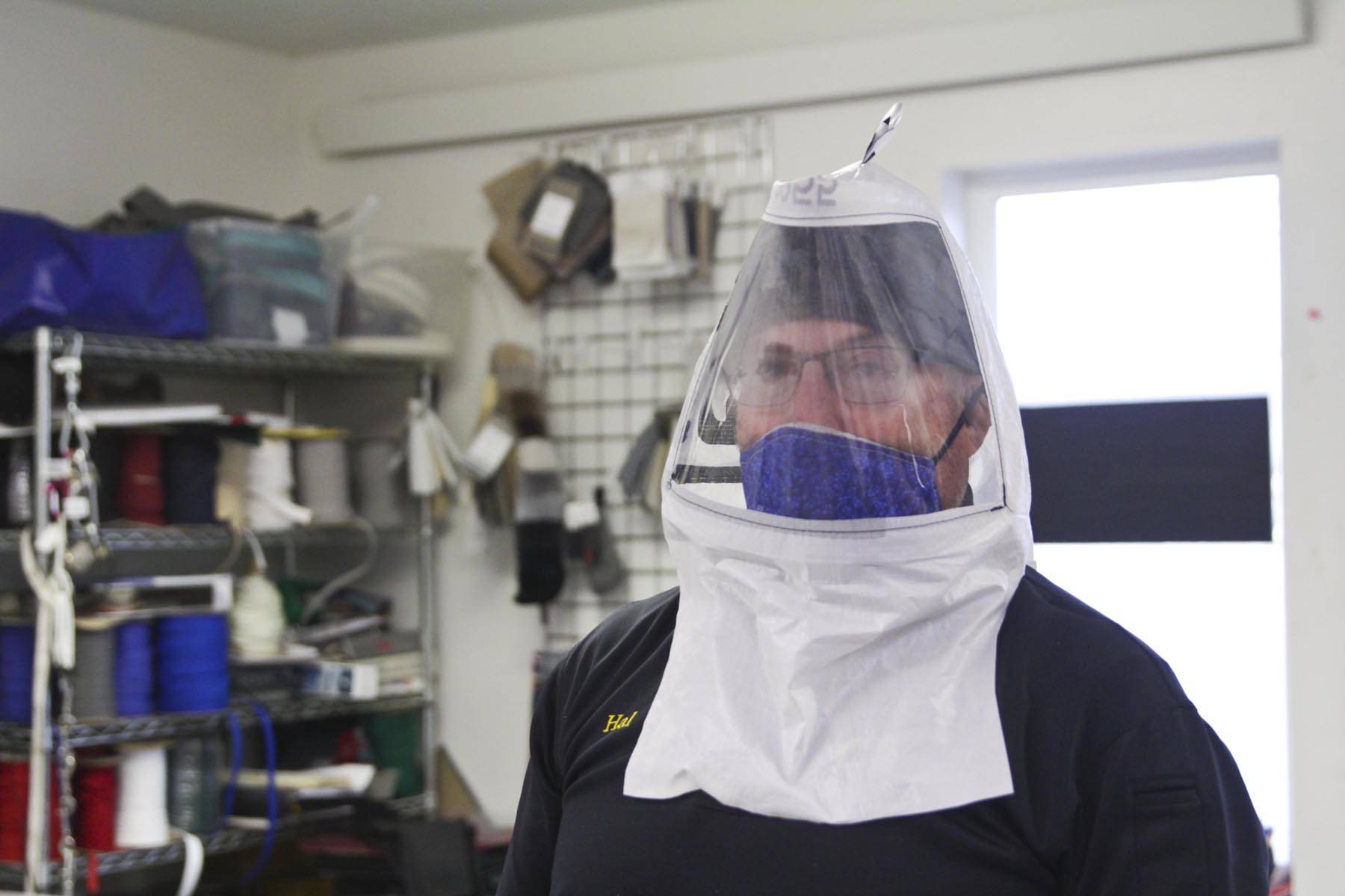 Michael S. Lockett | Juneau Empire                                Hal Daugherty shows off his hood design, to be put into production at his all-volunteer Southeast Regional Personal Protective Equipment Fabrication Facility, stood up in his sterilized workspace at Capital Canvas on March 27.