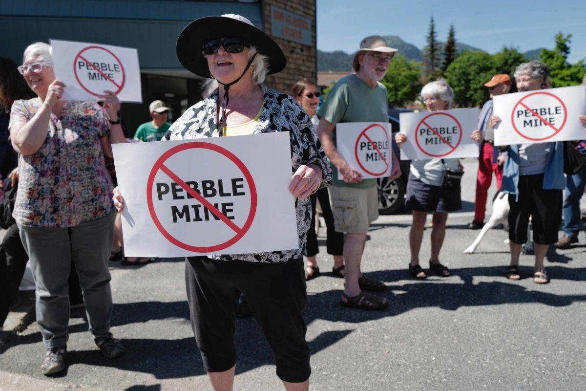 Judy Cavanaugh stands with others at a rally against the Pebble Mine in front of Sen. Lisa Murkowski’s Juneau office in July 2019. (Michael Penn | Juneau Empire File)