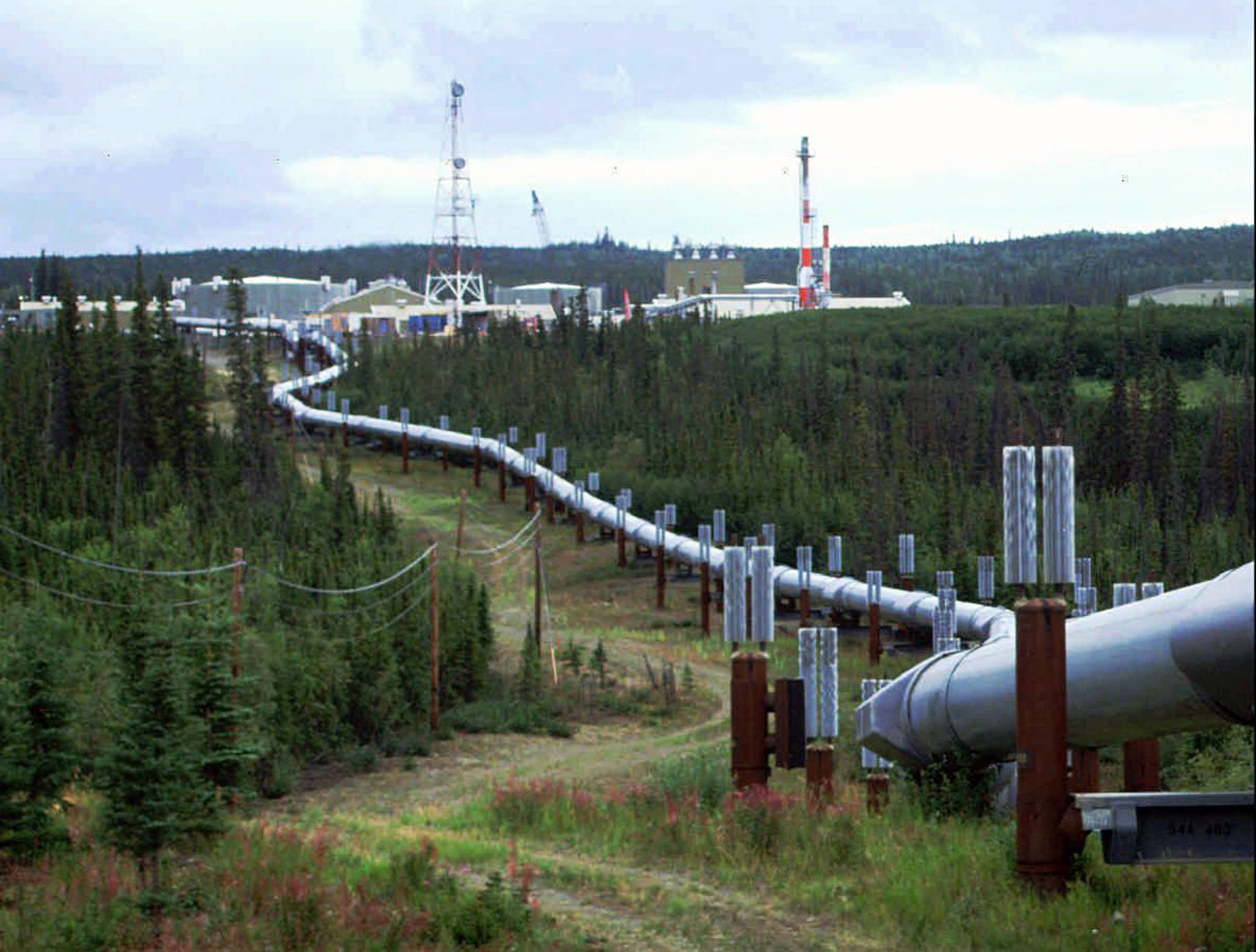 This undated file photo shows the Trans-Alaska pipeline and pump station north of Fairbanks, Alaska. The future of Alaska’s unique program of paying residents an annual check is in question, with oil prices low and an economy struggling during the coronavirus pandemic. (AP Photo/Al Grillo, File)