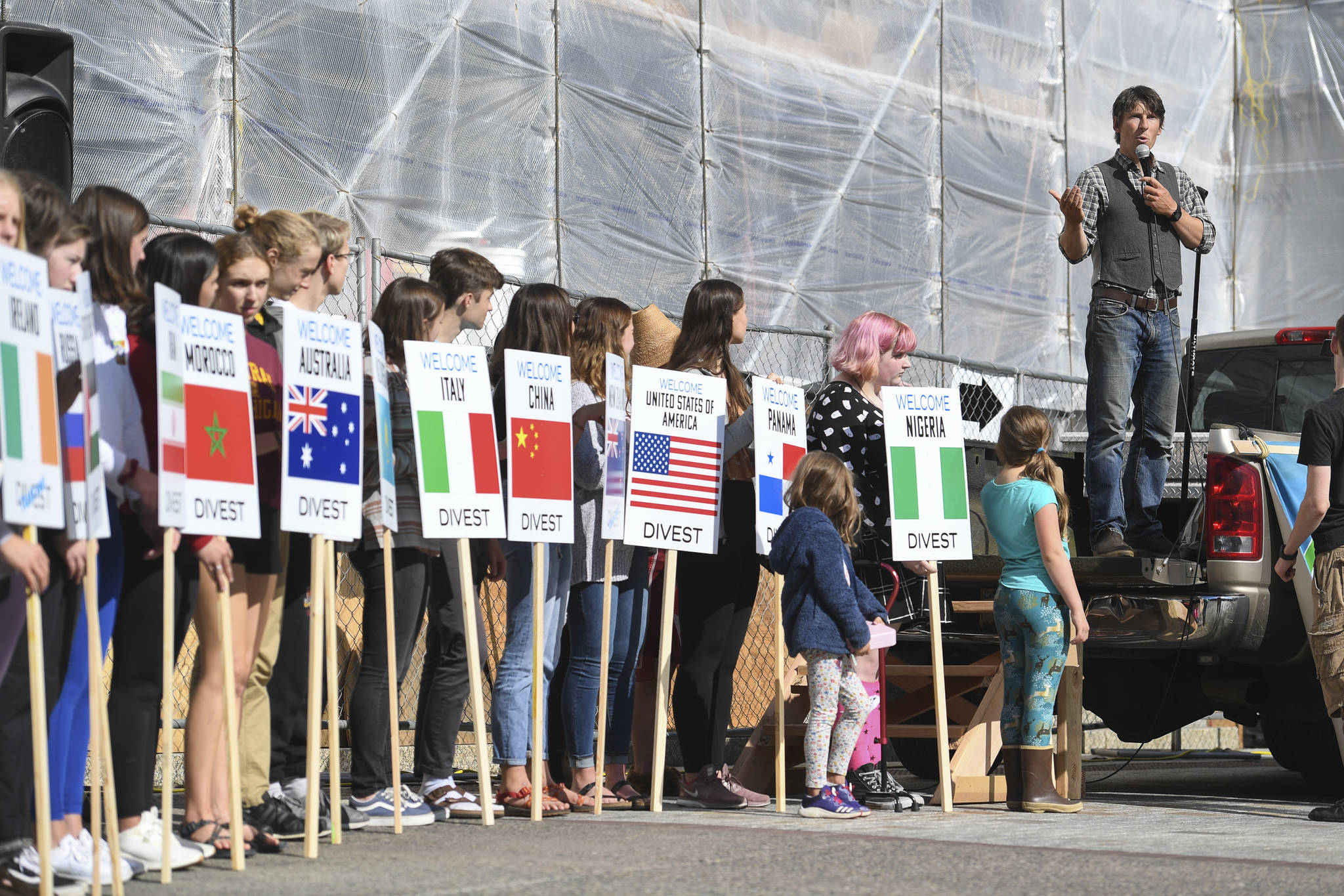 Zach Brown speaks during a “Stand Strong for Climate” rally in front of the Alaska State Capitol on Tuesday, Sept. 10, 2019 as students hold signs asking nations to divest from investments in the fossil fuel industry. (Michael Penn / Juneau Empire File)