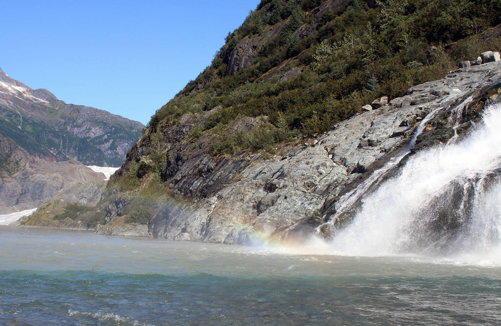 This Sept. 6, 2020, photo shows mist from Nugget Falls refracting light to create a prism-like effect. “Like many children I watched this summer, mine enjoyed climbing the glacially smoothed rock slopes up to the visitor center or down to the water at Photo Point. And hiking to Nugget Falls,” writes columnist Rich Moniak. (Ben Hohenstatt / Juneau Empire)