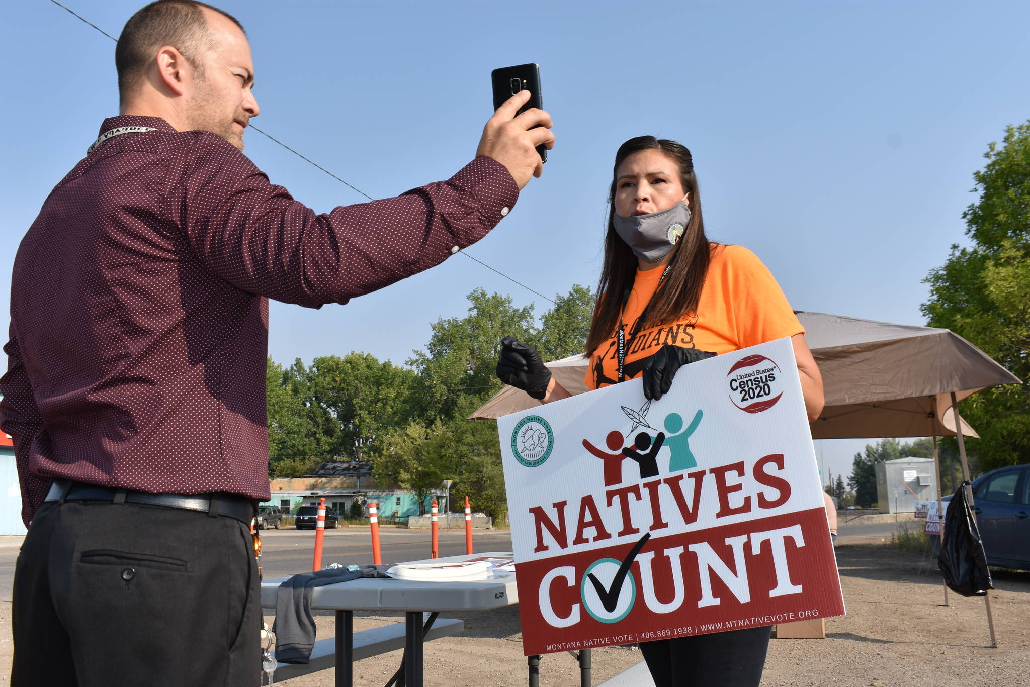 Activist Lauri Dawn Kindness, right, speaks at the Crow Indian Reservation, in Lodge Grass, Mont. on Wednesday, Aug. 26, 2020, as Lodge Grass Mayor Quincy Dabney records her for a social media campaign to increase Native American participation in the U.S. census. Kindness and other activists with Western Native Voice are trying to prevent an undercount of the tribe that could result in less federal funding. (AP Photo / Matthew Brown)