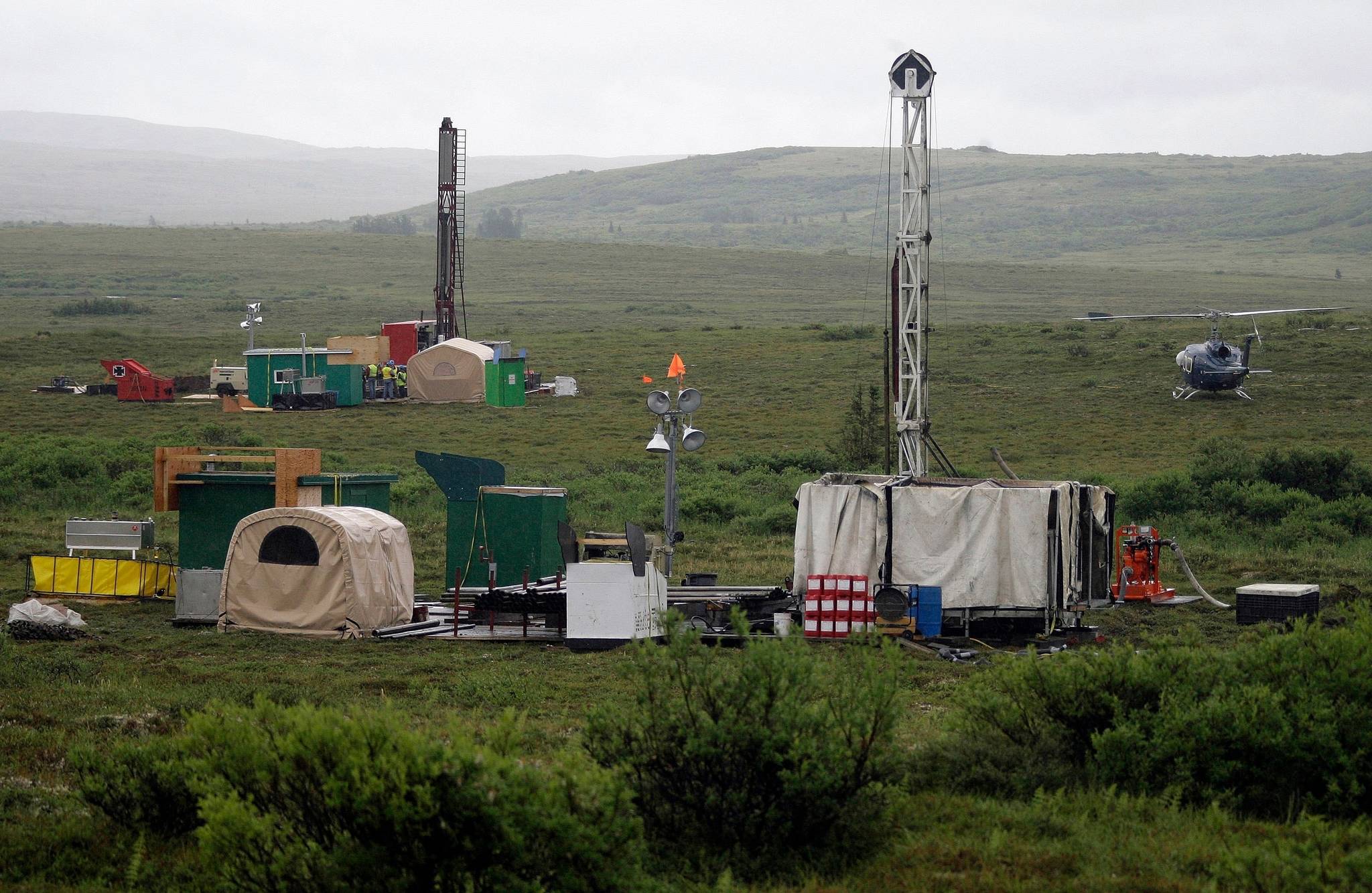 In this July 13, 2007, file photo, workers with the Pebble Mine project test drill in the Bristol Bay region of Alaska, near the village of Iliamma. A proposed gold and copper mine at the headwaters of the world’s largest sockeye salmon fishery in Alaska would cause “unavoidable adverse impacts,” the U.S. Army Corps of Engineers said in a letter to the developer released Monday, Aug. 24, 2020. The corps is asking the backers of Pebble Mine to come up with a mitigation plan within 90 days for nearly 3,000 acres of land and nearly 200 miles of streams it says could be affected if the controversial mine moves forward. (AP Photo / Al Grillo)