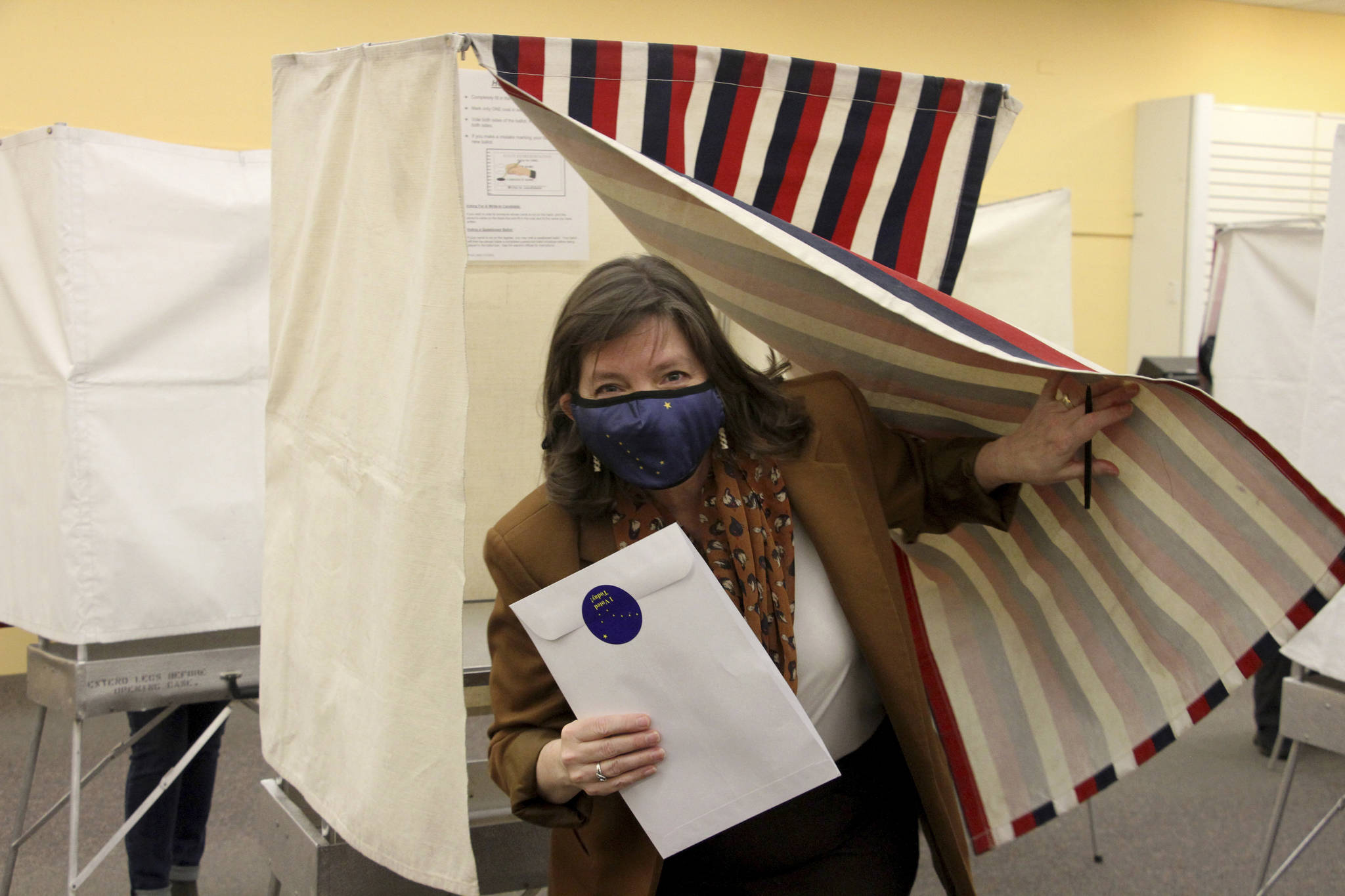 Alyse Galvin emerges from the voting booth after casting her early vote Friday, Oct. 30, 2020, in Anchorage, Alaska. Galvin, an independent, is trying to unseat U.S. Rep. Don Young, Alaska’s sole member of the U.S. House and in office since 1973. (AP Photo/Mark Thiessen)