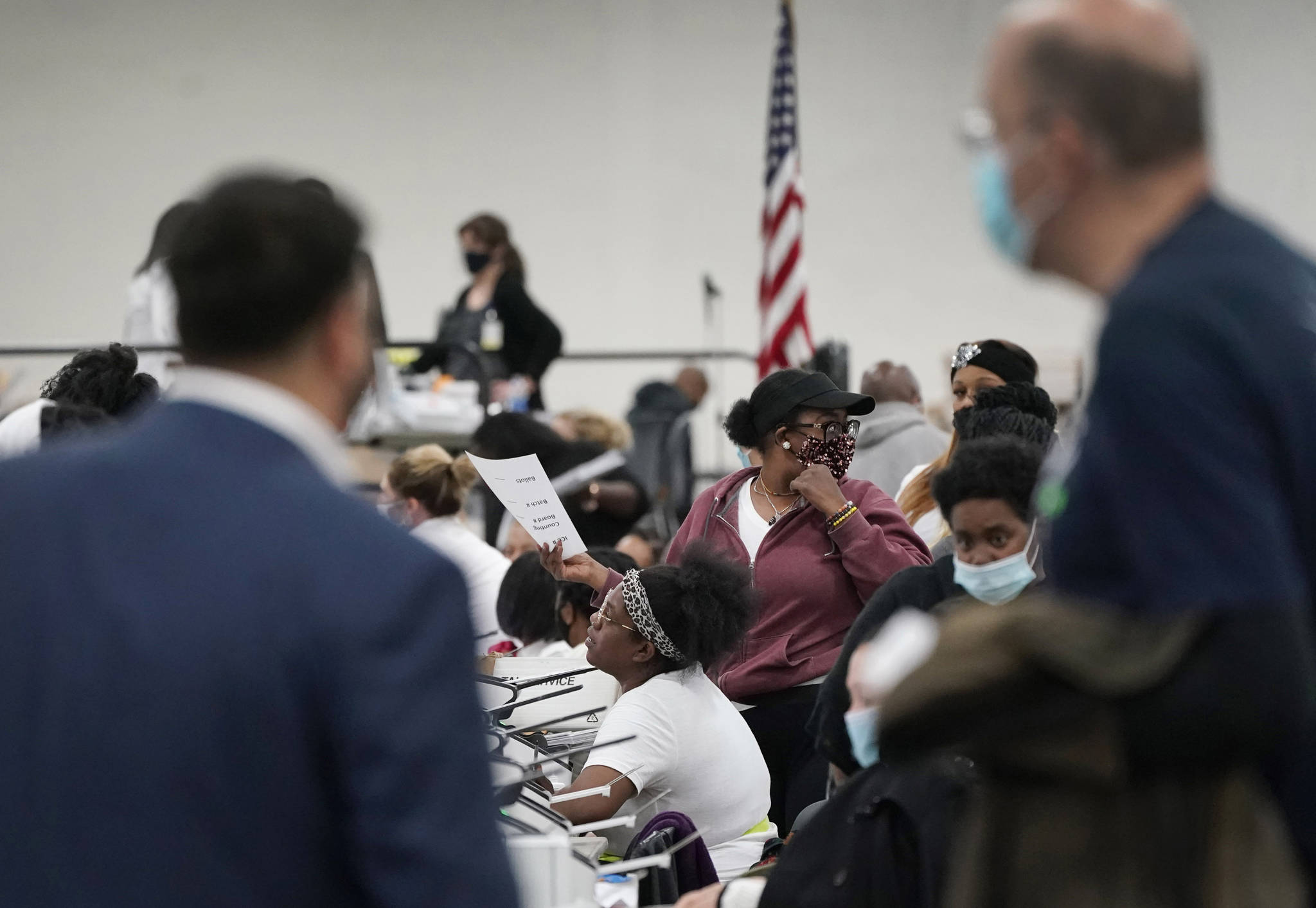 Election challengers observe as ballots are counted at the central counting board, Wednesday, Nov. 4, 2020, in Detroit. (AP Photo / Carlos Osorio)