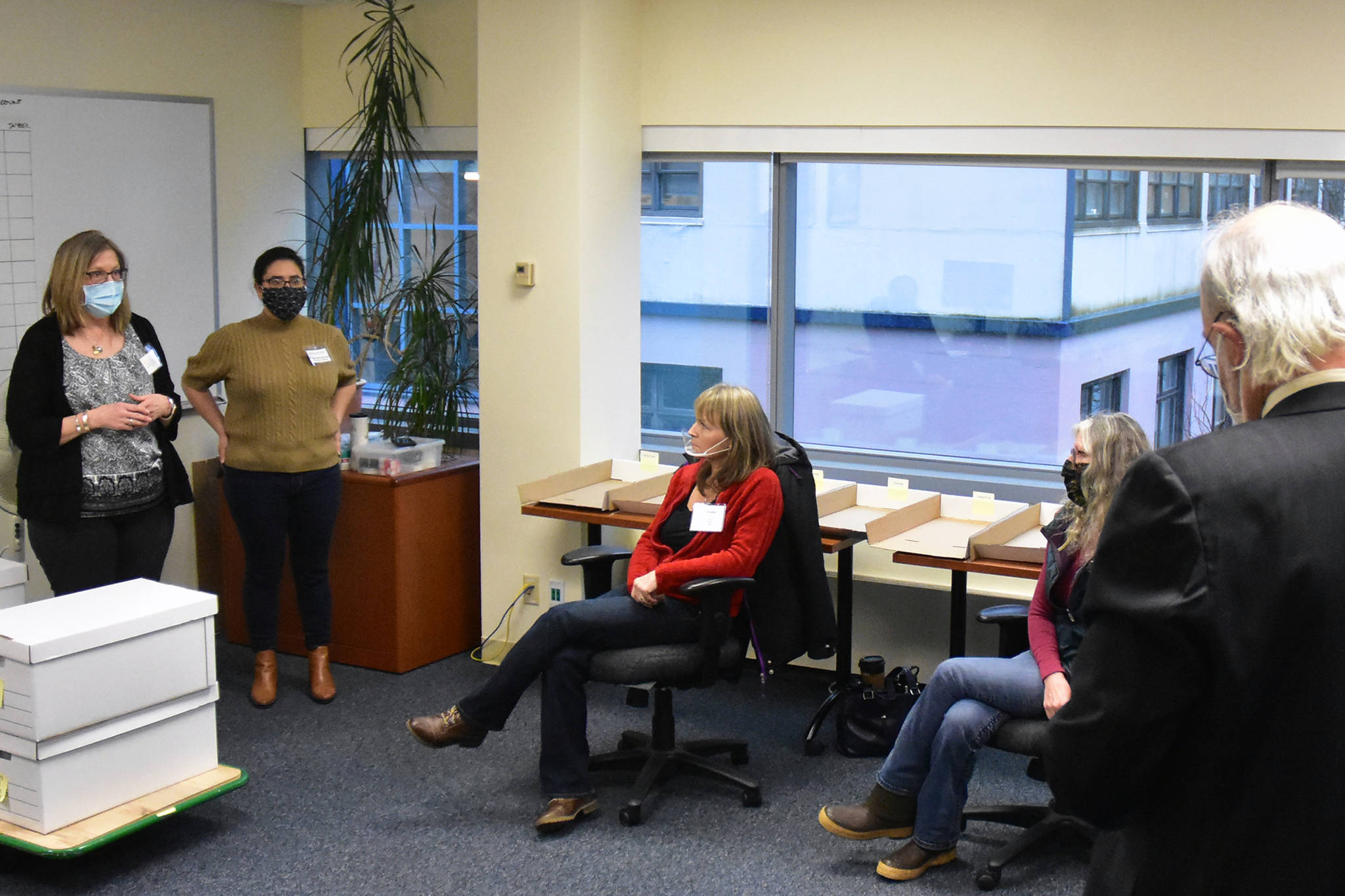 Division of Elections Director Gail Fenumiai, left, explains the recount process to DOE staff and members of the State Review Board during a recount of votes from Anchorage House District 27 where a Democratic challenger ousted a Republican incumbent by just 11 votes. Friday, Dec. 4, 2020. (Peter Segall / Juneau Empire)