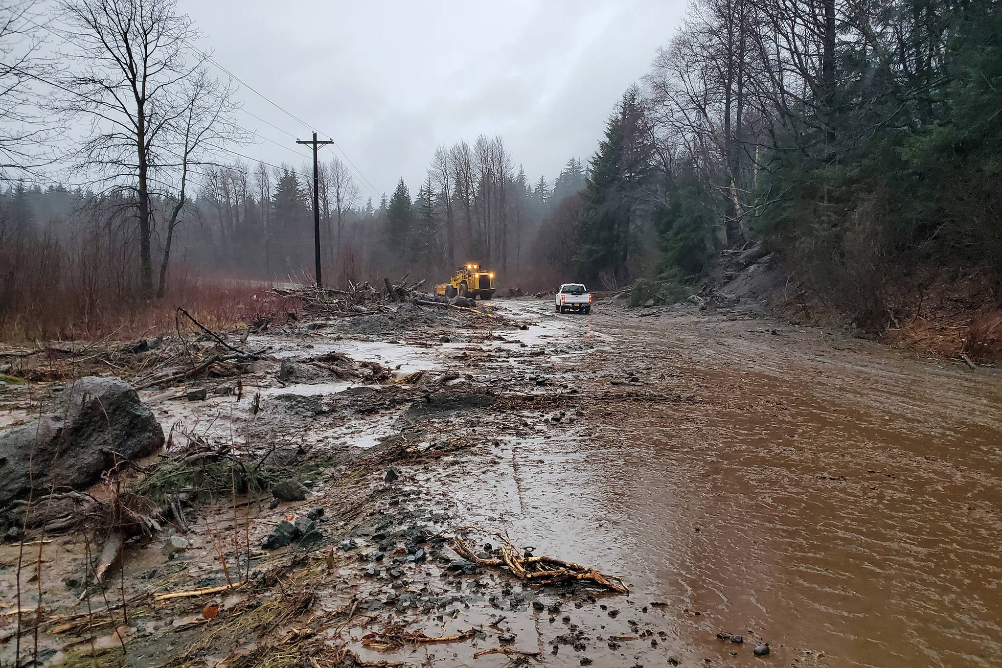 This photo provided by the Alaska Department of Transportation and Public Facilities shows damage from heavy rains and a mudslide 600 feet wide in Haines, Alaska, on Wednesday, Dec. 2, 2020. Authorities say six people are unaccounted for, and four homes were destroyed in the slide, with the search resuming Thursday morning for survivors. (Matt Boron / Alaska Department of Transportation and Public Facilities)