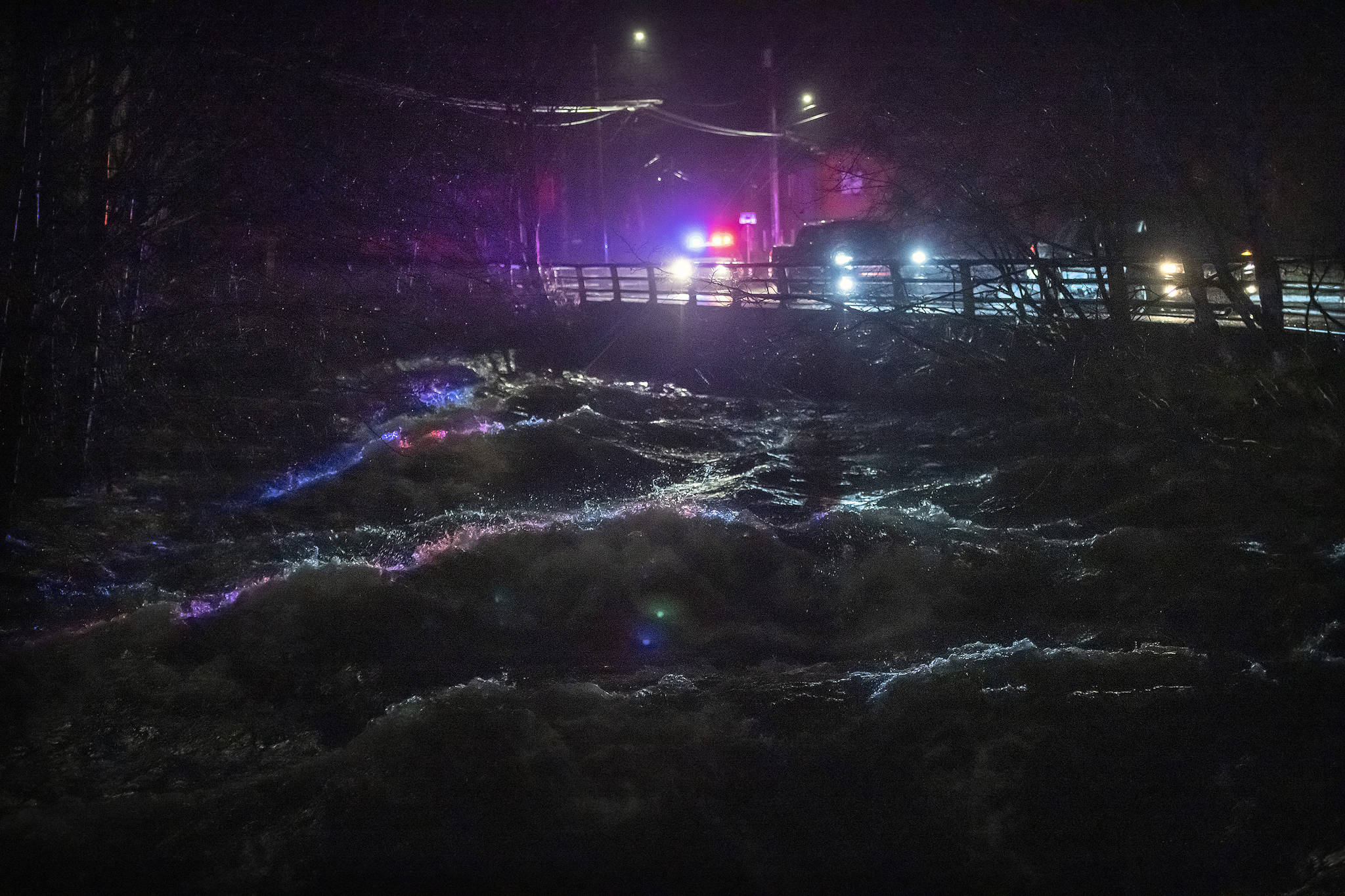 Ketchikan police and emergency response personnel deliver evacuation warnings to residents within a flood evacuation area that borders Ketchikan Creek, Saturday, Dec. 5, 2020, in Ketchikan, Alaska. Water levels were reported at 3-feet over the spillway at the Lower Ketchikan Lake dam. (Dustin Safranek / Ketchikan Daily News)