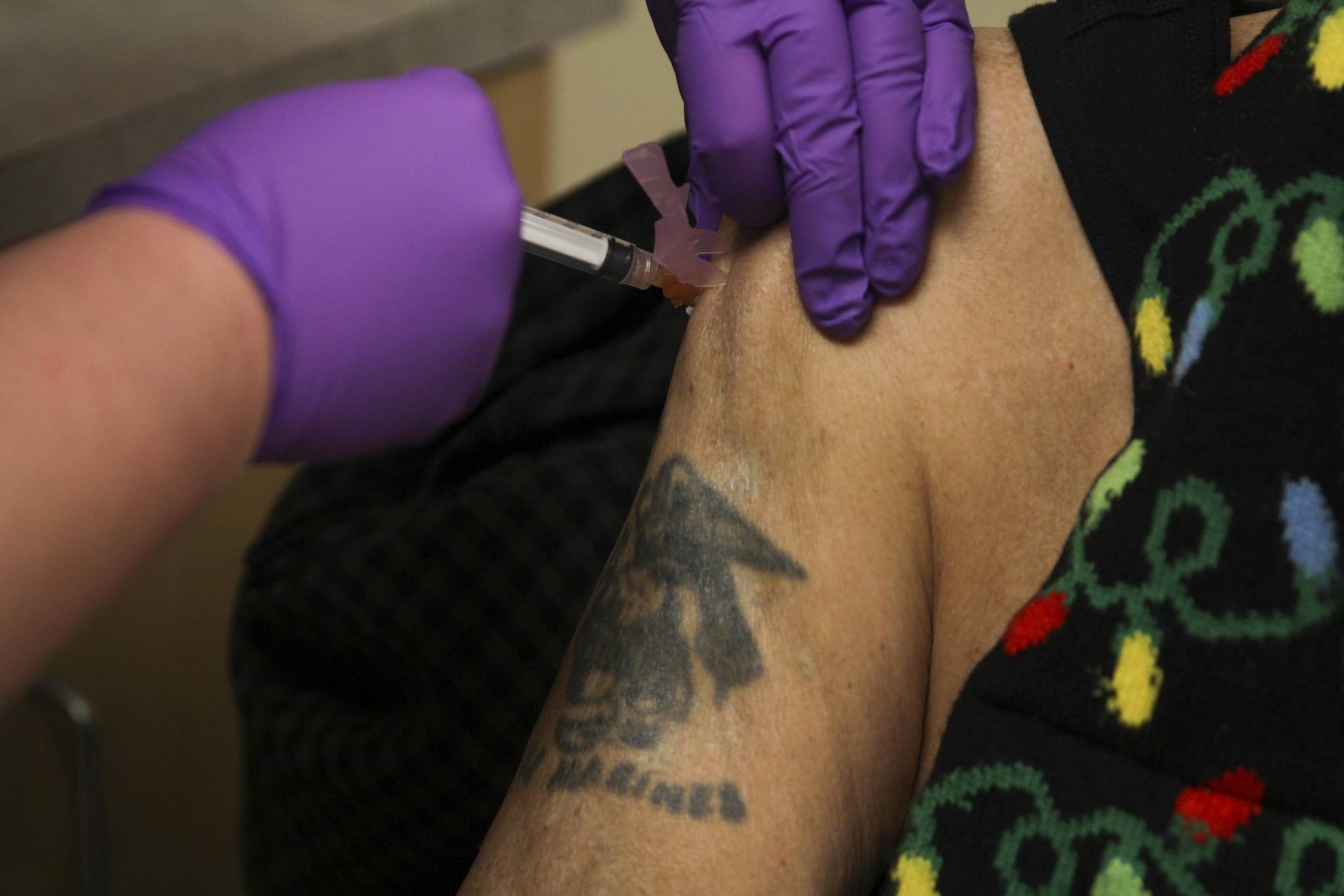 In this Dec. 24 photo, Arsenio “Pastor” Credo receives the Moderna coronavirus vaccine from nurse Courtney Taber at the Southeast Alaska Regional Health Consortium’s Ethel Lund Medical Center. (Michael S. Lockett / Juneau Empire)