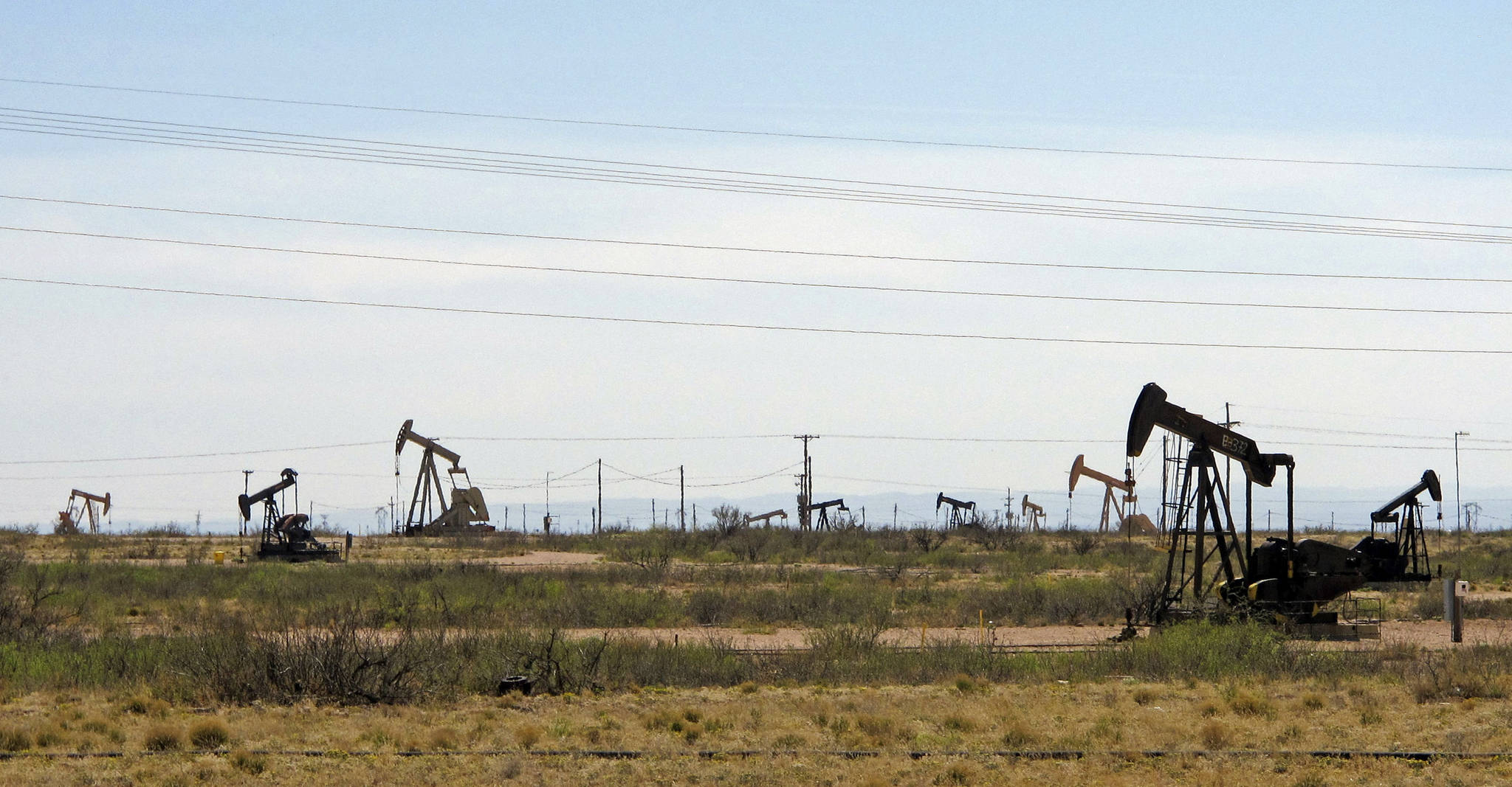 Oil rigs stand in the Loco Hills field on U.S. Highway 82 in Eddy County near Artesia, N.M., one of the most active regions of the Permian Basin. President Joe Biden is set to announce a wide-ranging moratorium on new oil and gas leasing on U.S. lands, as his administration moves quickly to reverse Trump administration policies on energy and the environment and address climate change. (AP Photo/Jeri Clausing, File)