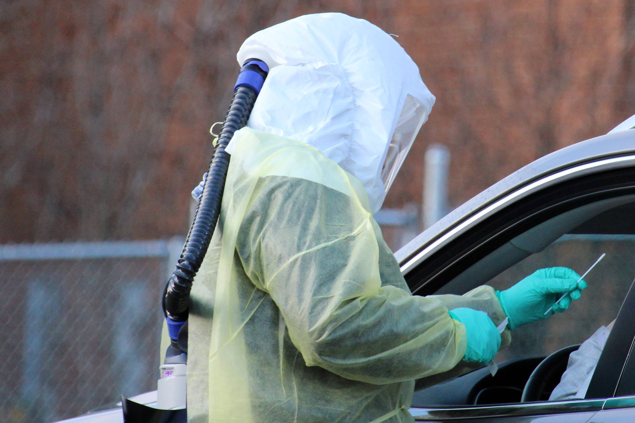 Sarah Palmer holds up a swab before administering a COVID-19 test in late December. The state announced on Tuesday that a variant of the virus that causes COVID-19 had been detected in Alaska for the first time. (Ben Hohenstatt / Juneau Empire)