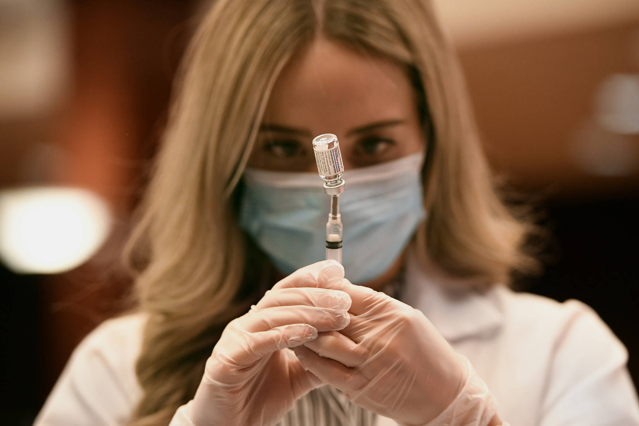 Pharmacist Madeline Acquilano draws a syringe of Johnson & Johnson COVID-19 at Hartford Hospital in Hartford, Conn., Wednesday, March 3, 2021. The first shipments of the vaccine arrived at the hospital this morning. Cities and states are rapidly expanding access to vaccines as the nation races to head off a resurgence in coronavirus infections and reopen schools and businesses battered by the pandemic. (AP Photo/Jessica Hill)