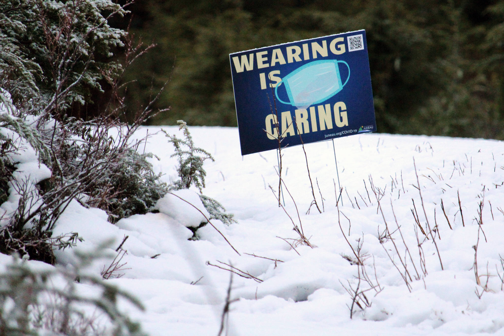 A sign along Montana Creek Road encourages Juneau residents to wear face masks in public settings on Dec. 29. The (Ben Hohenstatt / Juneau Empire File)