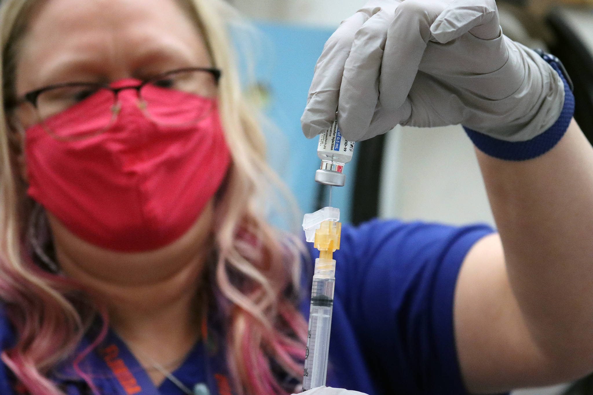 Sandi Eldridge, pharmacist for the Department of Veterans Affairs, draws a dose of Johnson & Johnson vaccine on March 13, 2021. (Ben Hohenstatt / Juneau Empire file)