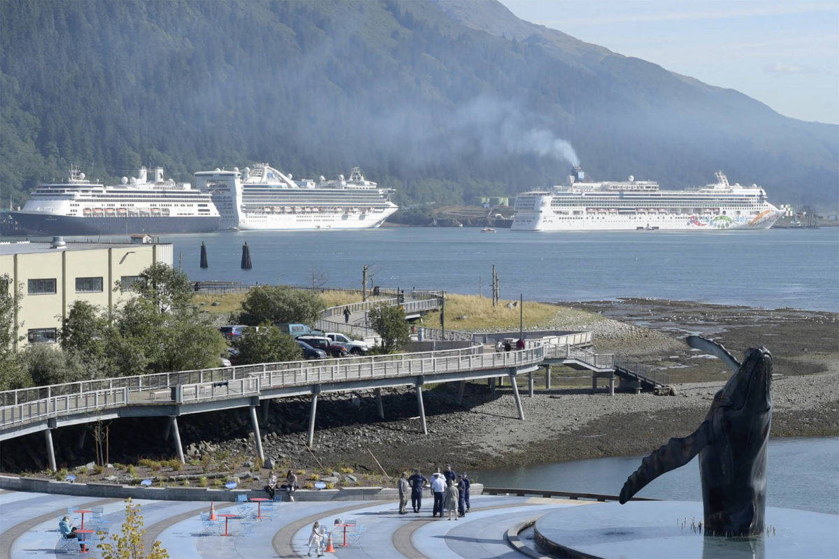 The Norwegian Pearl cruise ship, right, pulls into the AJ Dock in Juneau in September 2018. (Michael Penn/Juneau Empire File)