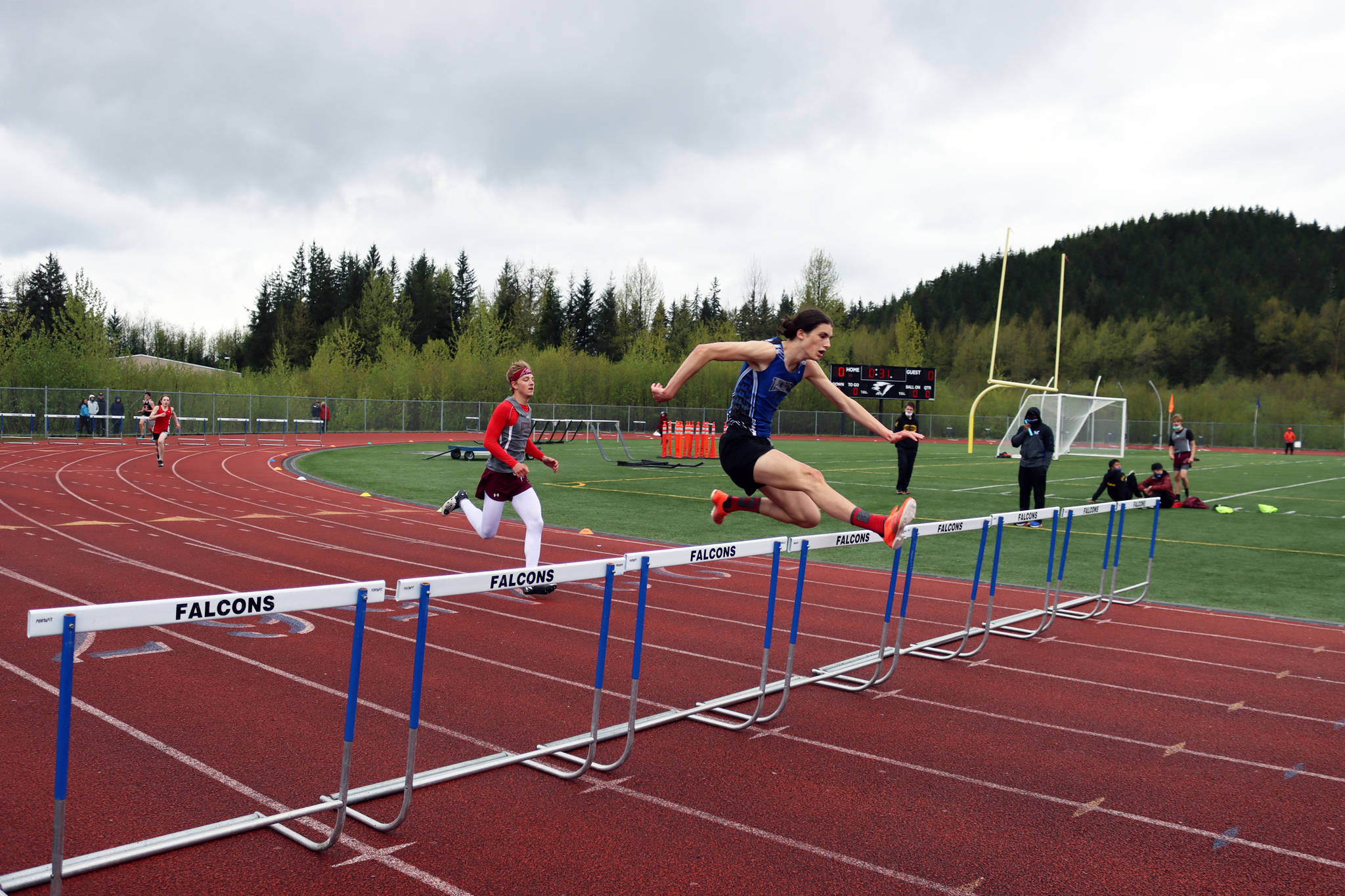 Eli Mead of Thunder Mountain High School jumps a hurdle during the Region V Track Meet at TMHS on Saturday, May 22. Mead finished first in the 300 hurdles for Region V, Division 1.	(Ben Hohenstatt / Juneau Empire)