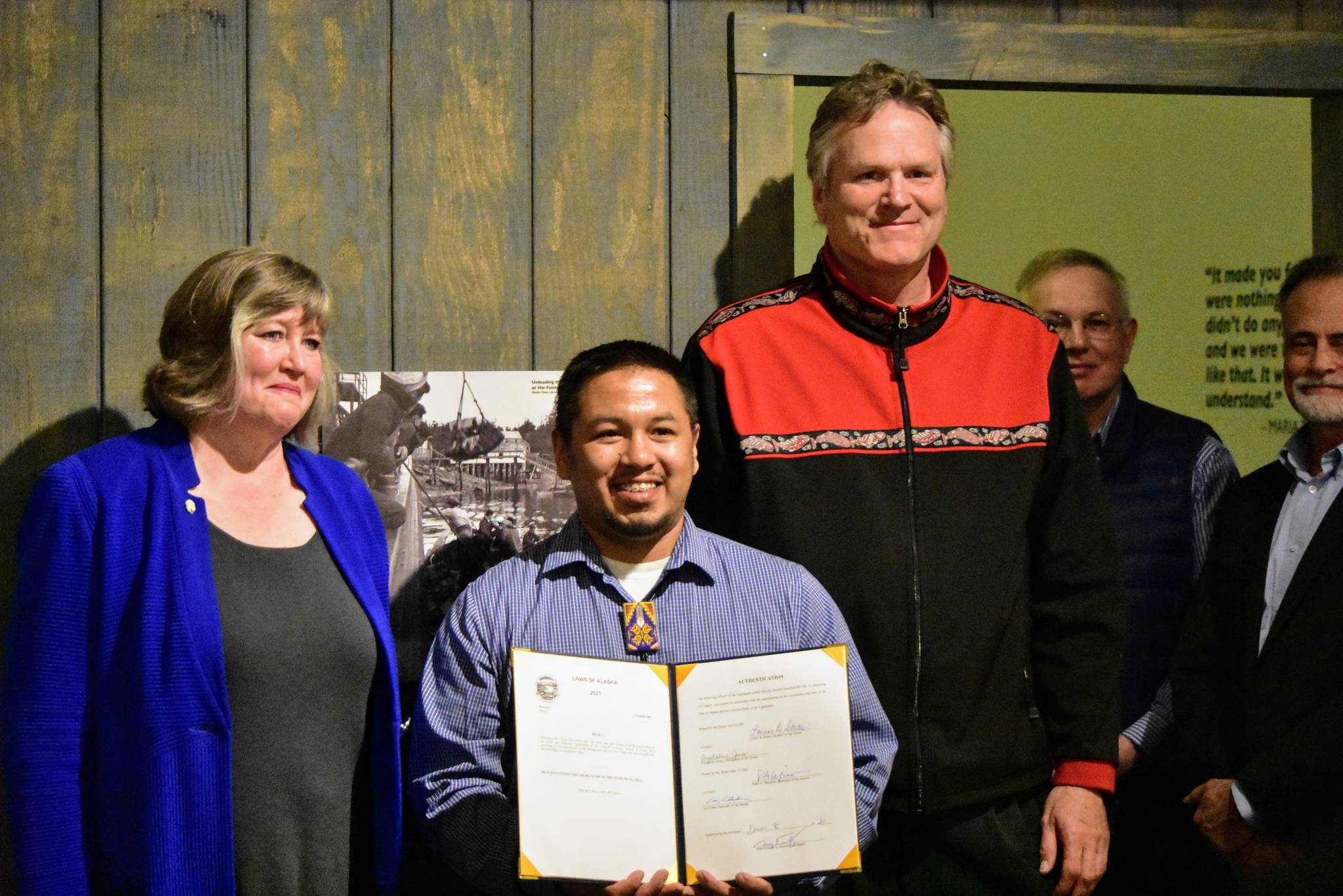 From left to right, Rep. Sara Hannan, D-Juneau; Martin Stepetin Sr. and Gov. Mike Dunleavy at a signing ceremony for a bill protecting a cemetery in Funter Bay at the Juneau-Douglas City Museum on Tuesday, June 8, 2021. (Peter Segall / Juneau Empire)