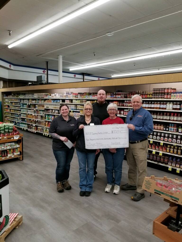 Courtesy Photo 
This photo shows Kelly Crow, Super Bear IGA store director; Kathy Benner, Juneau Raptor Center manager; JP Oudekerk, Super Bear IGA assistant manager; Pat Bock with Juneau Raptor Center; and Rick Wilson, Foodland IGA/Ace Hardware store director.