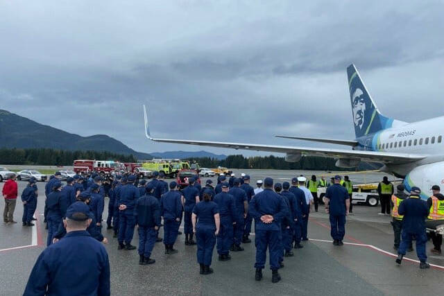 Coast Guardsmen stand in formation at Juneau International Airport as the body of Chief Petty Officer Jeffery DeRonde, who died over the weekend, is loaded on an airplane on Sept. 7, 2021. (Courtesy photo / Capital City Fire/Rescue)