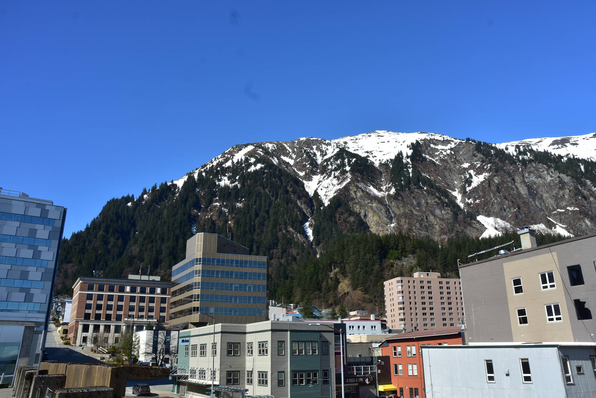 Mount Juneau, looms above downtown Juneau in this April 2021 photo. (Peter Segall / Juneau Empire File)