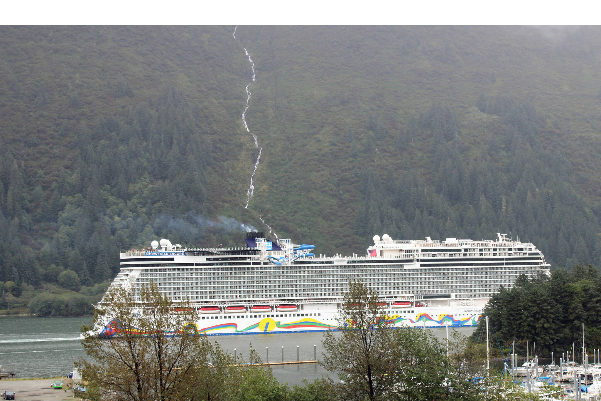 The Norwegian Encore slips past Douglas Island on Sept. 8, as part of 2021's abbreviated cruise season. In 2020, COVID-19 halted all cruise traffic. Earlier this year, Norwegian Cruise Lines announced $10 million in donations to communities hard hit by 2020’s pandemic-induced suspension on cruising, including $2 million to organizations in Juneau. Recently, local organizations have started to receive the money. (Dana Zigmund/Juneau Empire)