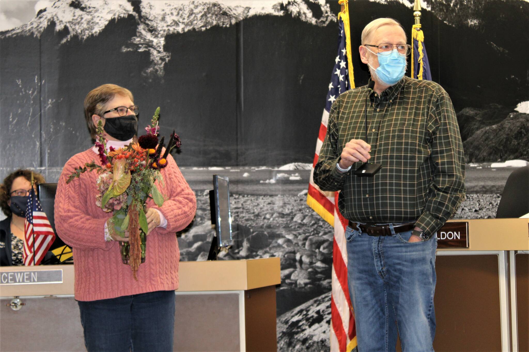 Long-serving City and Borough of Juneau Assembly member Loren Jones, addresses the crowd at his last assembly meeting on Oct. 25. His wife of almost 52 years, La Rae Jones, stands beside him. (Dana Zigmund / Juneau Empire File)