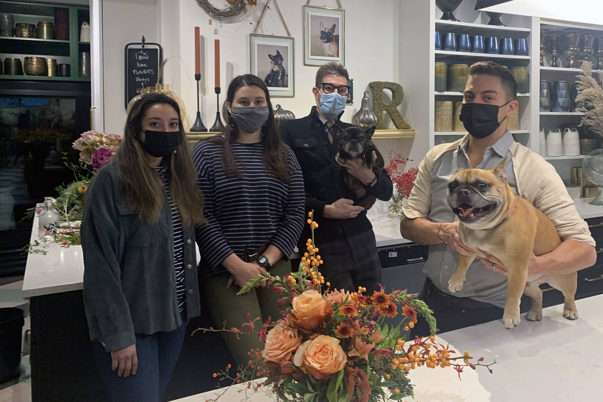 Dana Zigmund/Juneau Empire
The staff at Frenchie’s Floral Studio downtown takes a break from preparing Thanksgiving arrangements on Friday, Nov. 12. Florist Heather Alducin, (left), floral designer, Nikki Box, (second left), stand with shop owners Jeremy Bauer, (center right), and Jason Clifton, (right). French bulldogs George (held by Bauer) and Gracie (on table), served as the inspiration for the shop’s name.