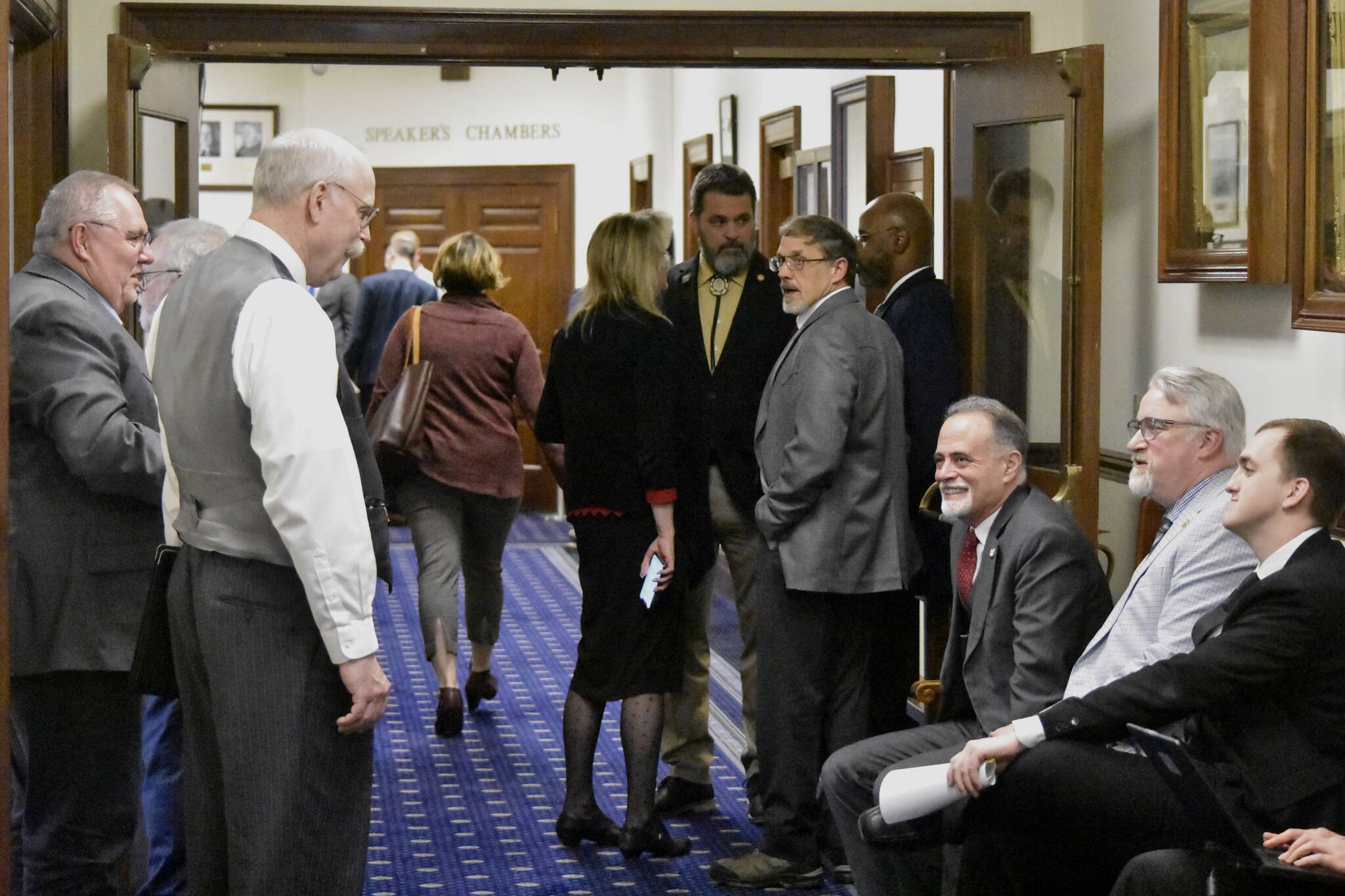 Lawmakers from both bodies of the Alaska State Legislature mingle in the halls of the Alaska State Capitol on Wednesday, May 18, 2022, the last day of the legislative session, following the Senate's passing of the state's budget bill. (Peter Segall / Juneau Empire)