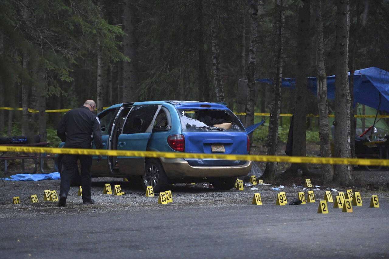 Evidence markers are placed around the scene of a shooting in Centennial Park campground in Anchorage, Alaska, Wednesday, July 20, 2022. (Bill Roth / Anchorage Daily News)