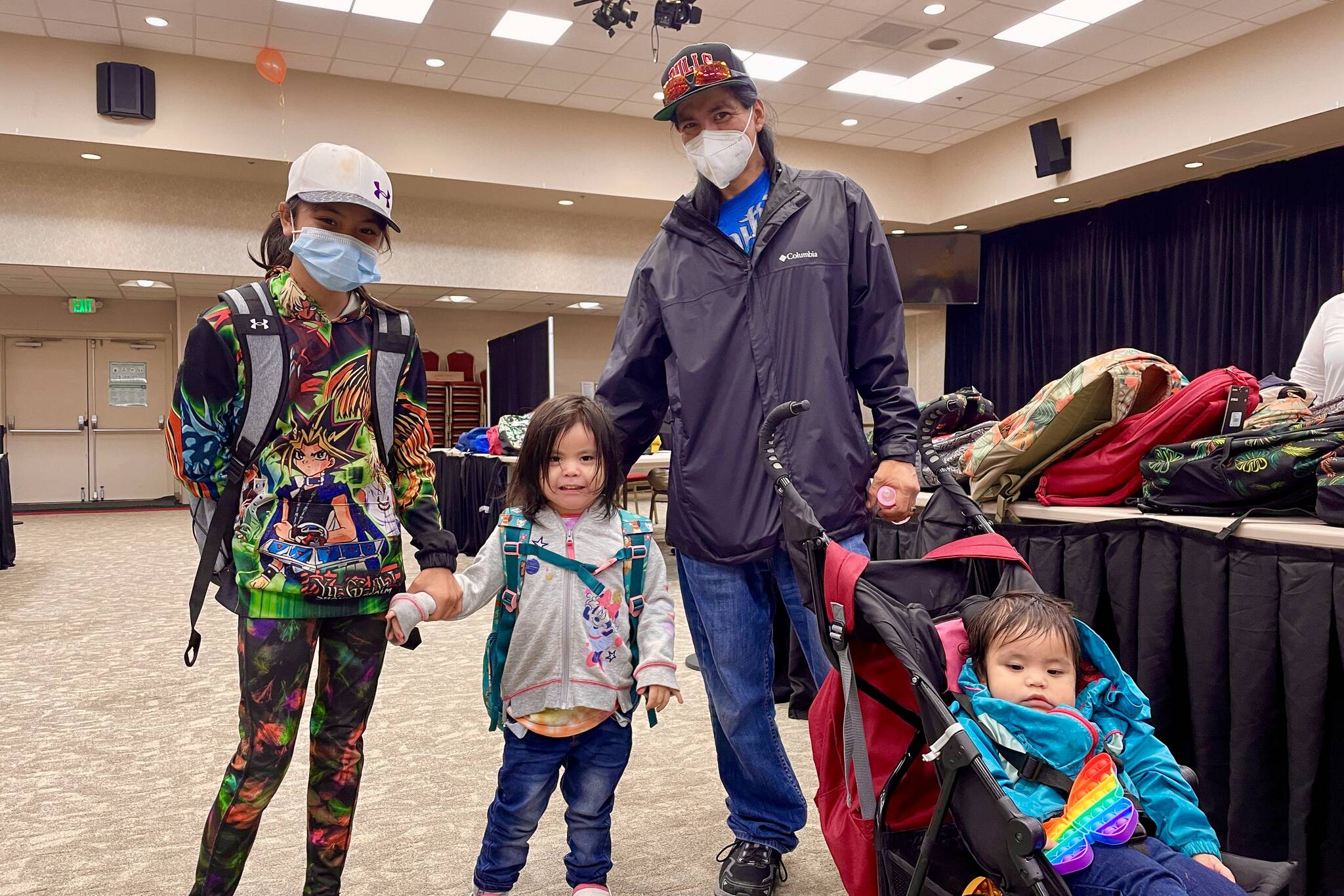 Students show off their new backpacks at Central Council of the Tlingit and Haida Indian Tribes of Alaska’s annual backpack distribution at Elizabeth Peratrovich Hall on July 23, 2022. (Michael S. Lockett / Juneau Empire)