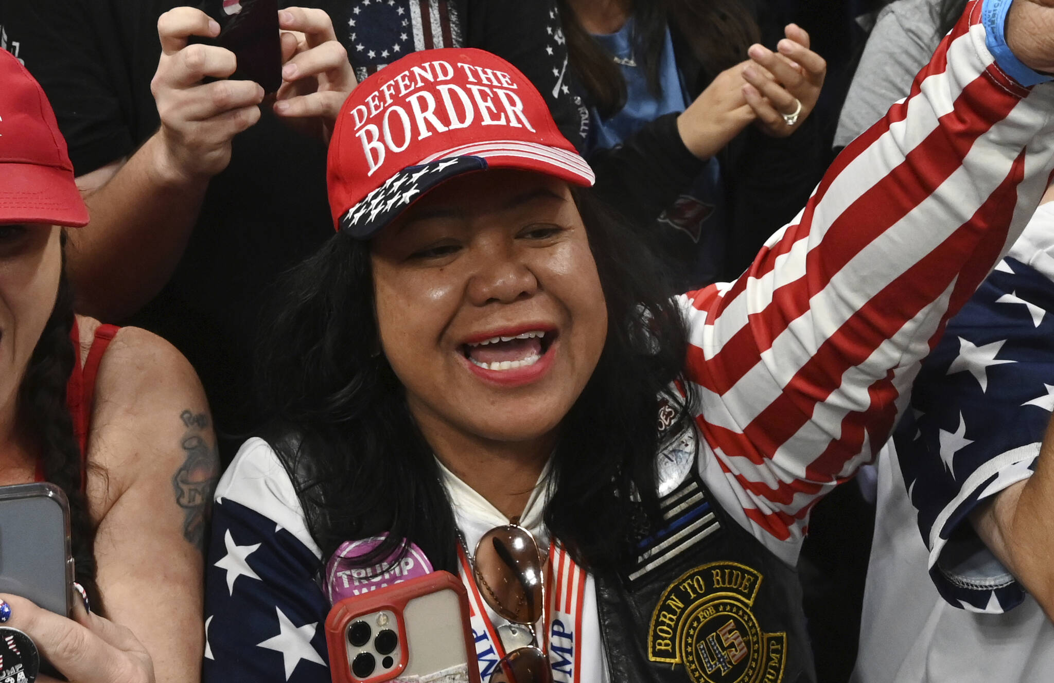 Mimi Israelah, center, cheers for Donald Trump inside the Alaska Airlines Center in Anchorage, Alaska, during a rally Saturday July 9, 2022. Two Anchorage police officers violated department policy during a traffic stop last month when Israelah, in town for a rally by former President Donald Trump showed a “white privilege card” instead of a driver’s license and was not ticketed. (Bill Roth / Anchorage Daily News)