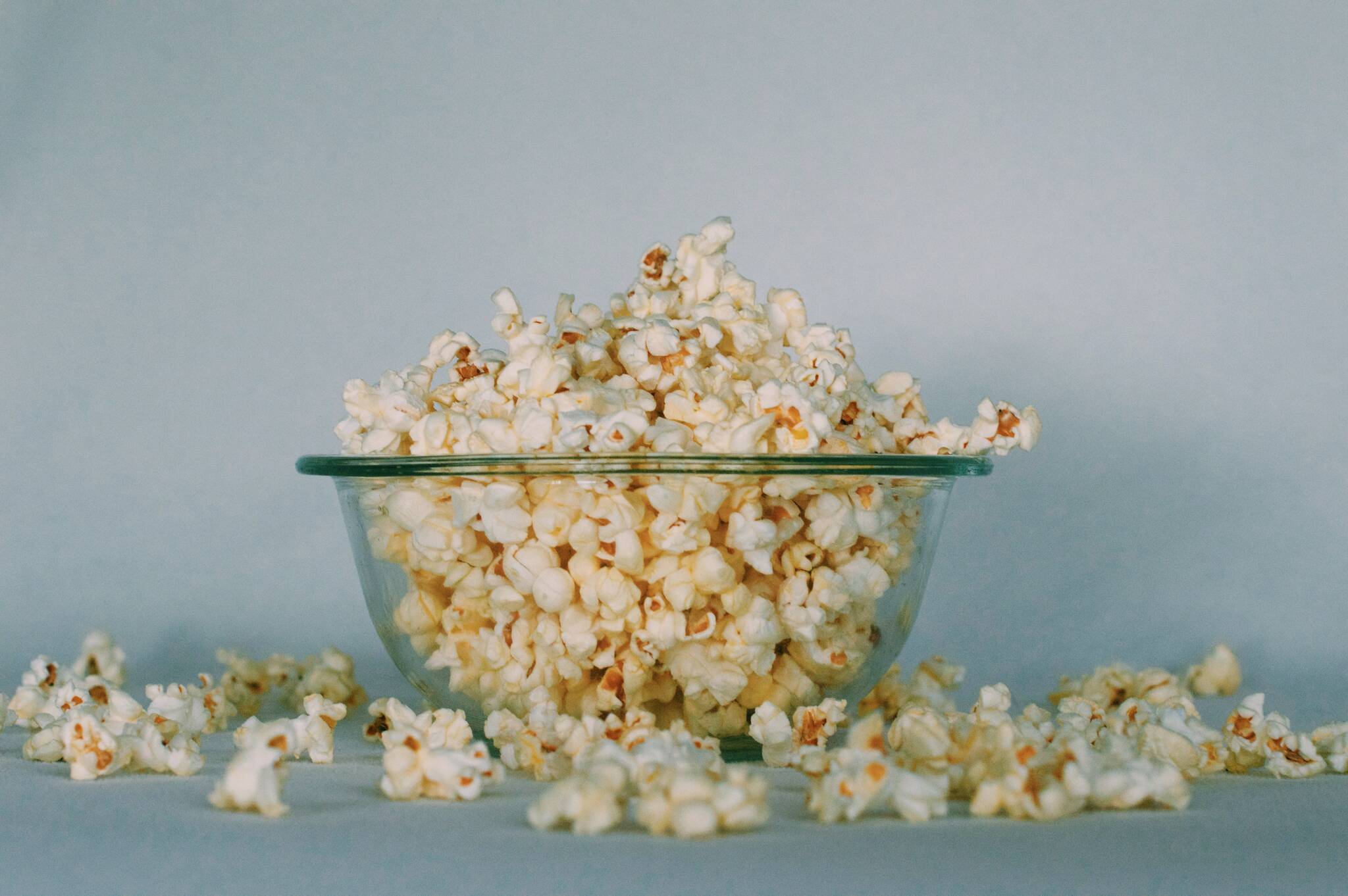 This photo shows a bowl of popcorn. “I love popcorn. When I play those ice-breaker games where you introduce yourself and name a favorite food, I always say, ‘Peggy, popcorn.’ writes Peggy McKee Barnhill. “It has a pleasing alliteration, making it easy for people to remember my name. Plus, it’s the truth. I love popcorn.” (Georgia Vagim / Unsplash)