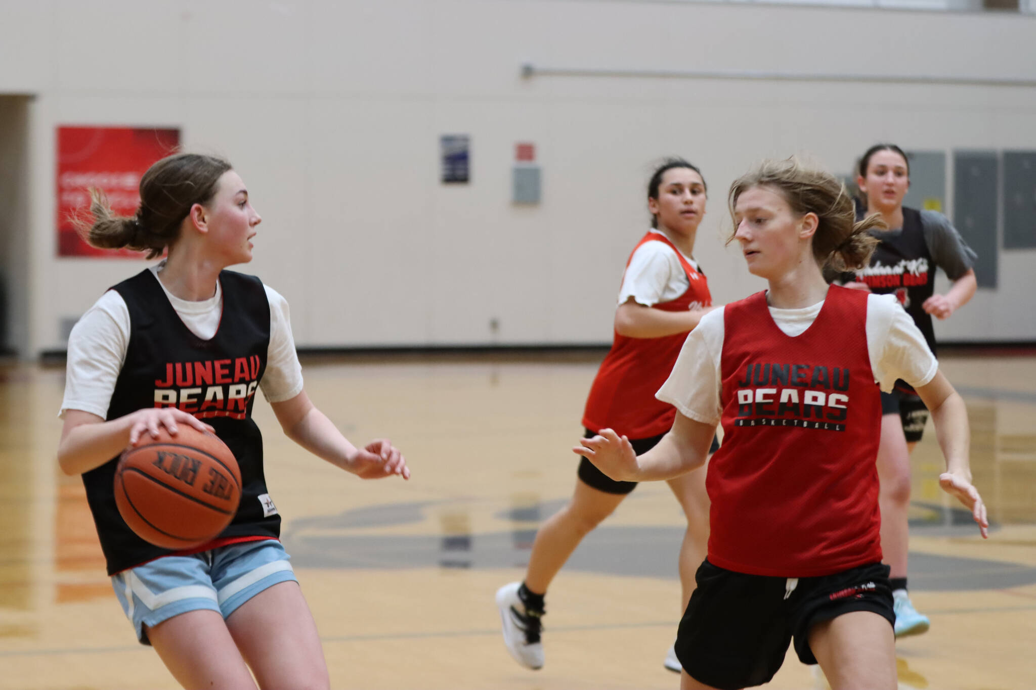 JDHS freshman Gwen Nizich squares off against senior Skylar Tuckwood at a practice Wednesday night with senior Kiyara Miller and Nadia Wilson nearby. (Jonson Kuhn / Juneau Empire)